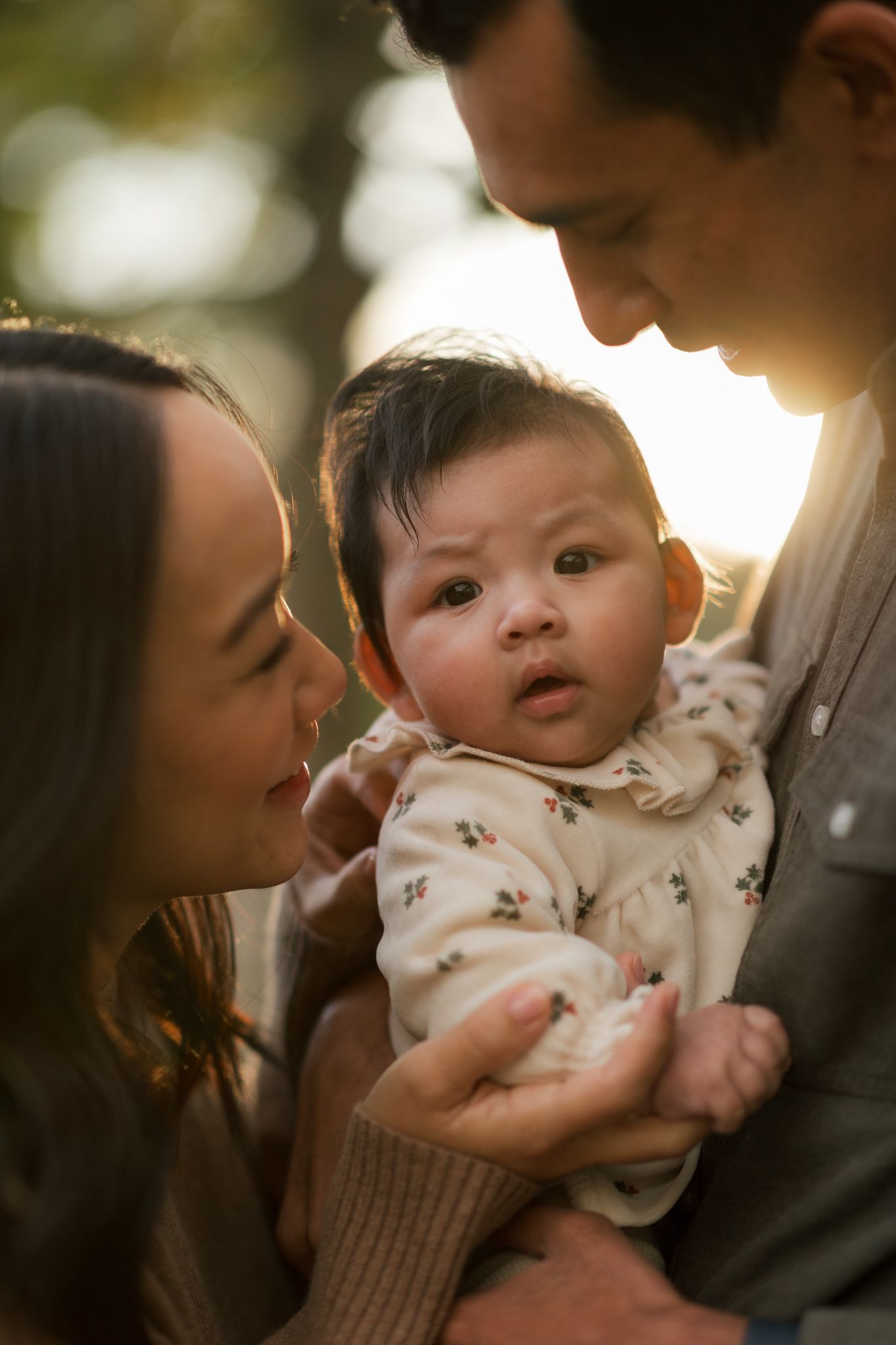 Intimate family moments captured in warm sunlight with soft bokeh effects.