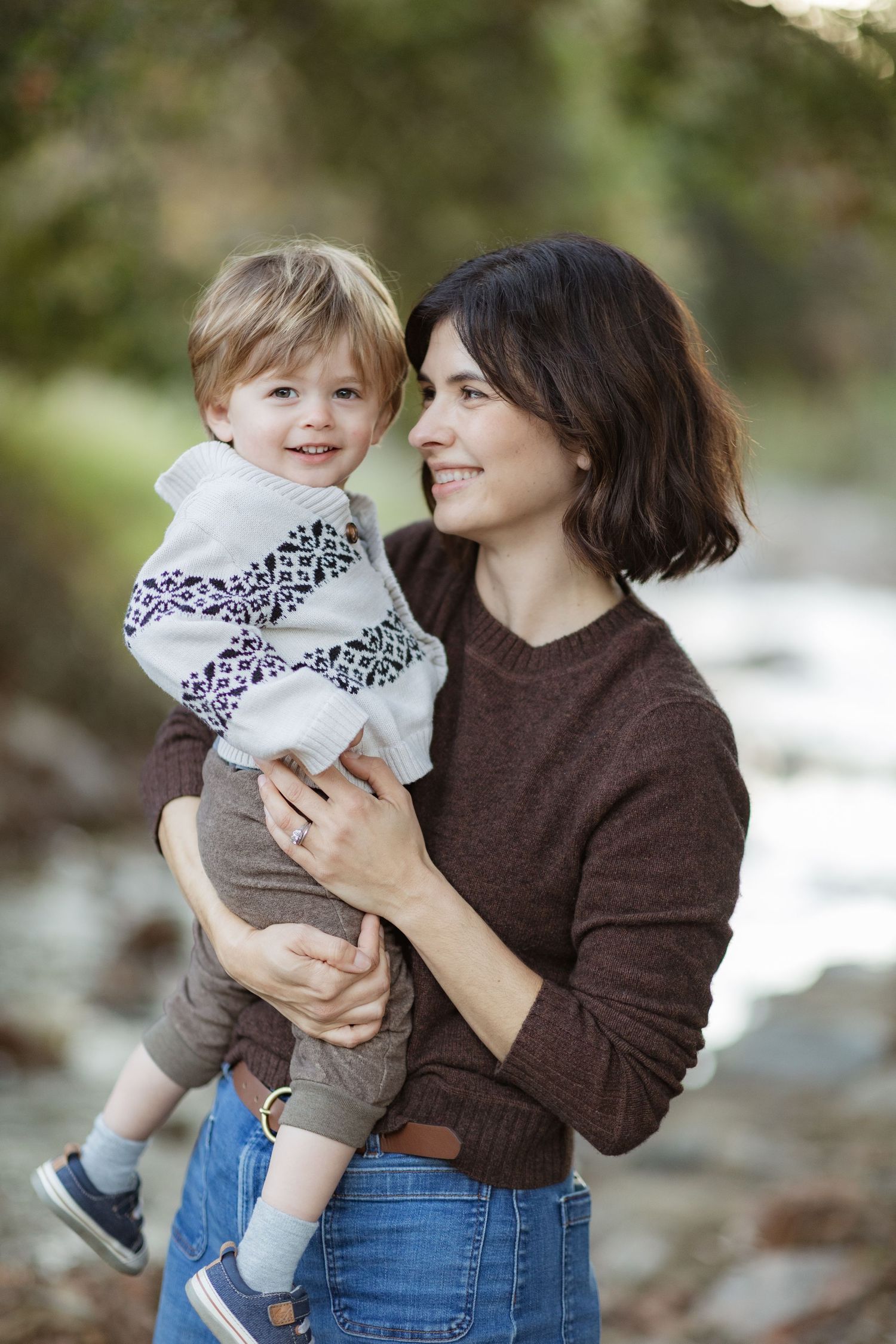 Sweet outdoor family portraits showing tender moments between parent and child.