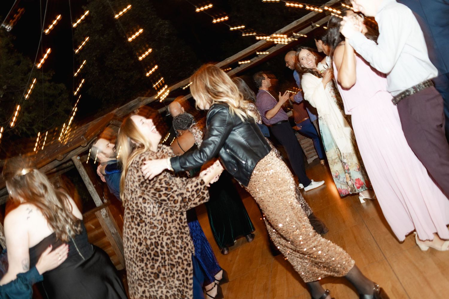 Lively dance floor scenes at a wedding reception with motion blur and party lights.