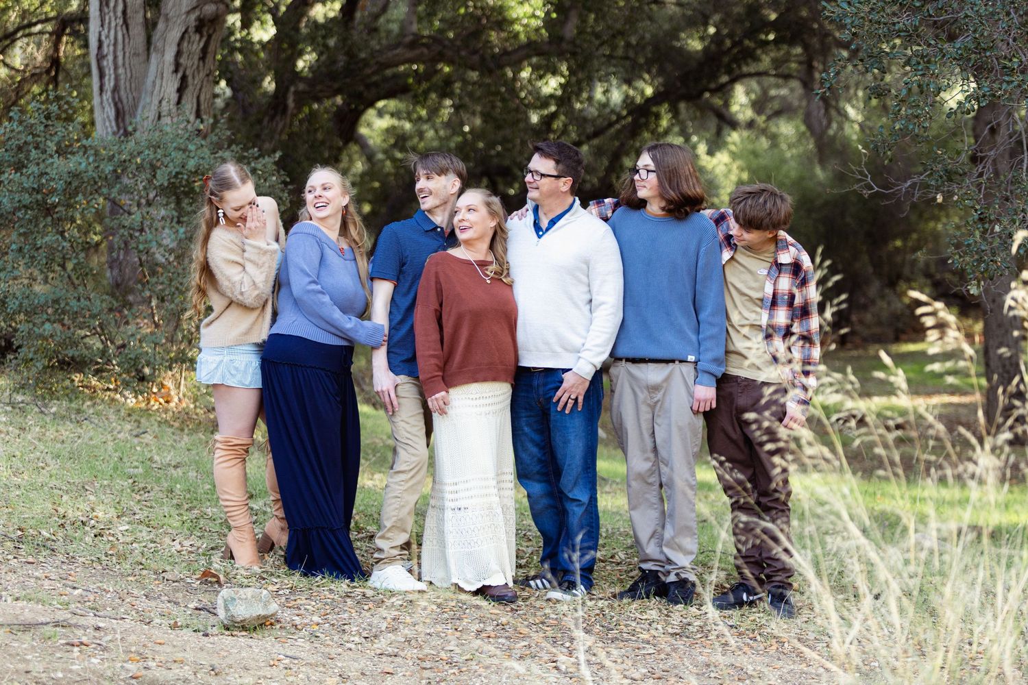 Extended family gathered outdoors for a casual group photo session.