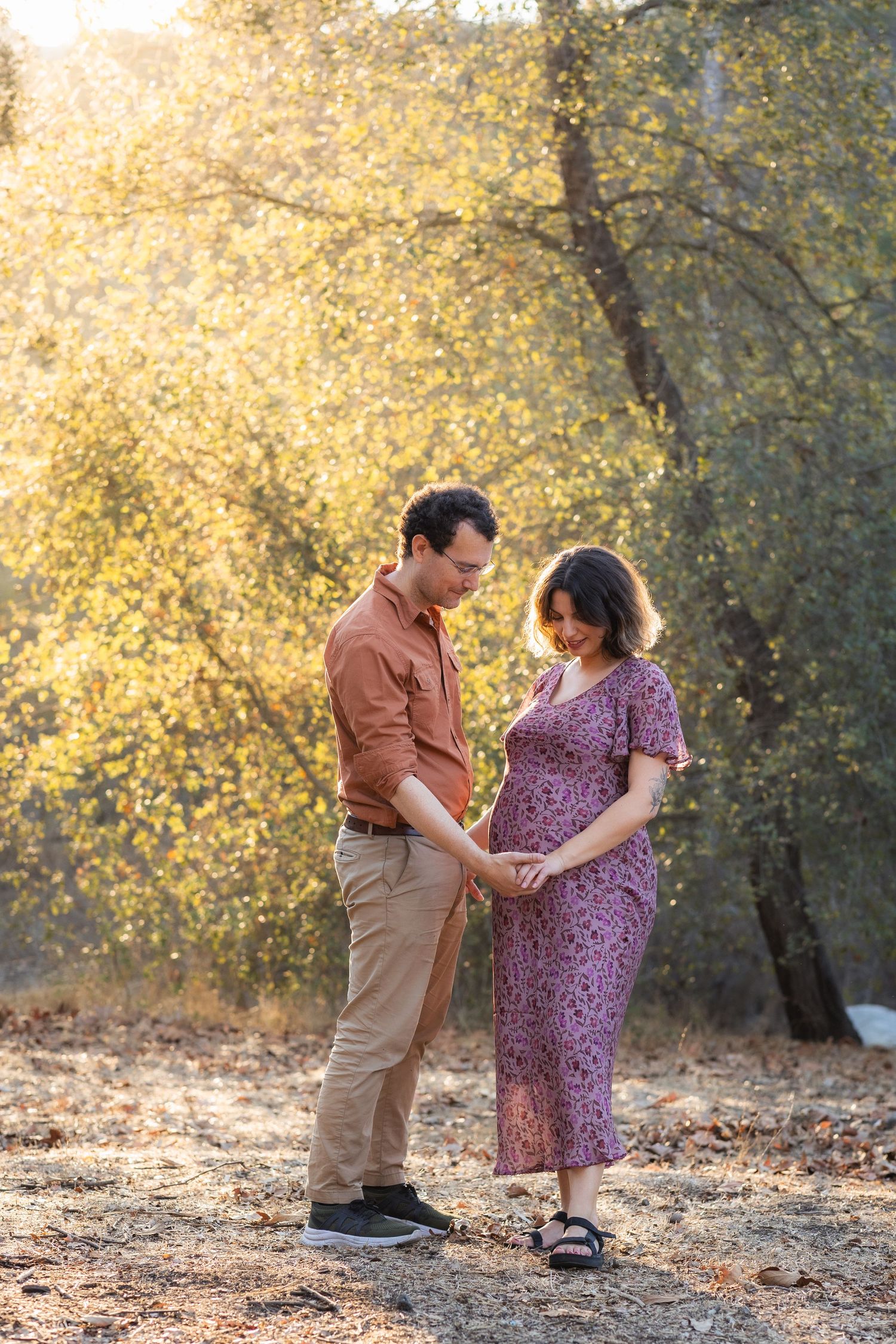 Couple in autumn setting sharing an intimate moment outdoors.