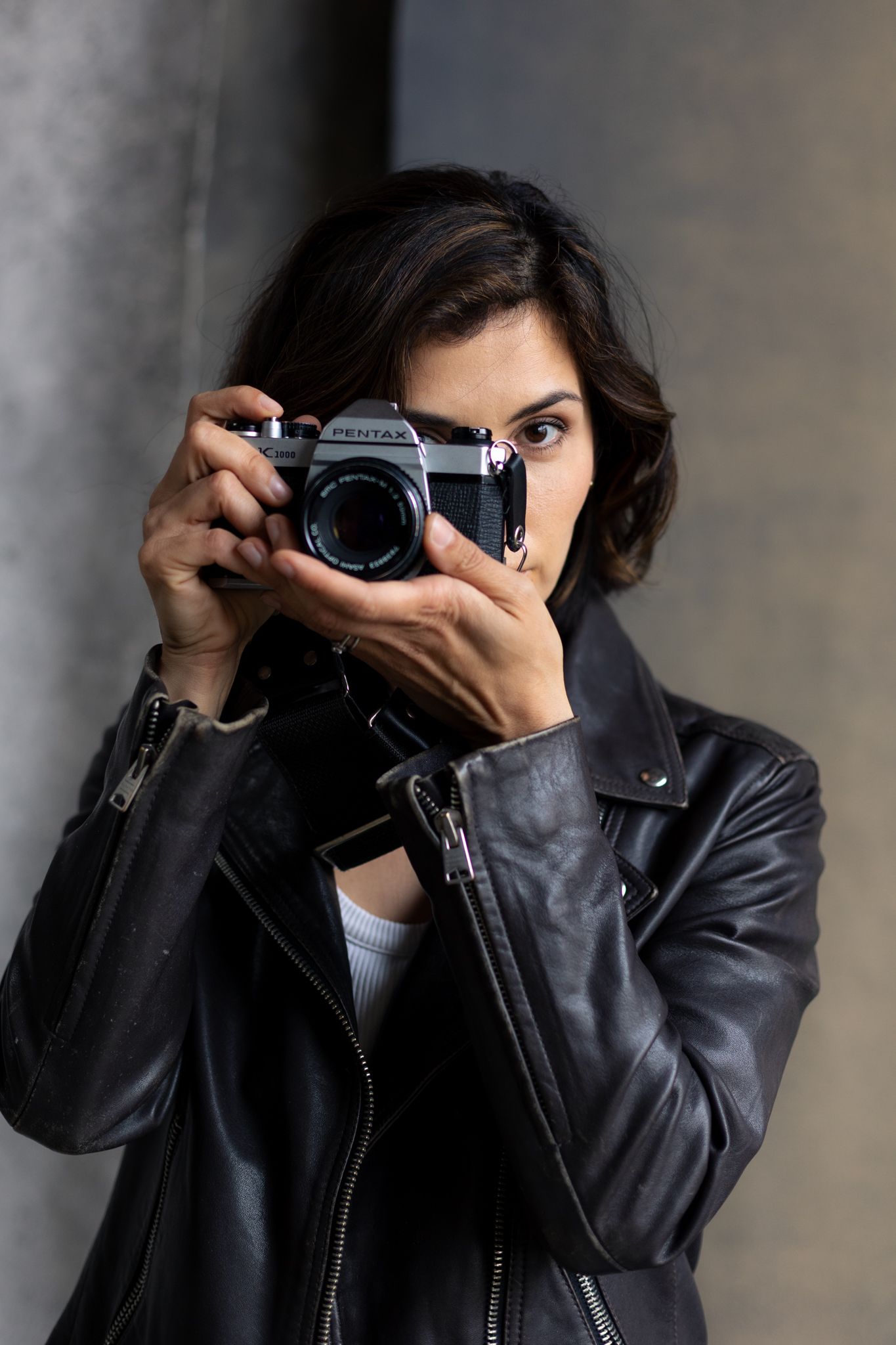 Portrait photographer using vintage film camera.