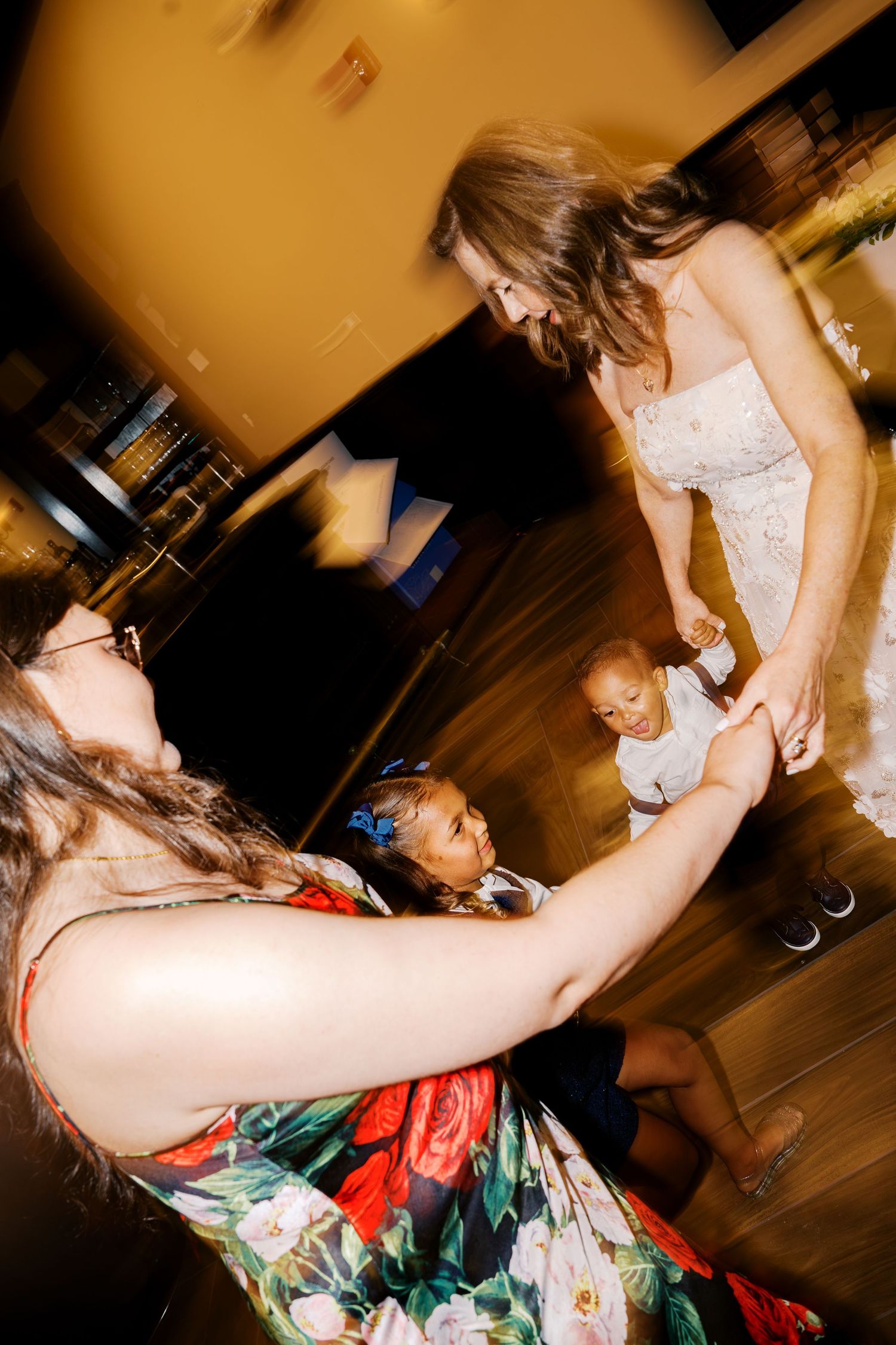 People dancing and celebrating at a lively wedding reception.