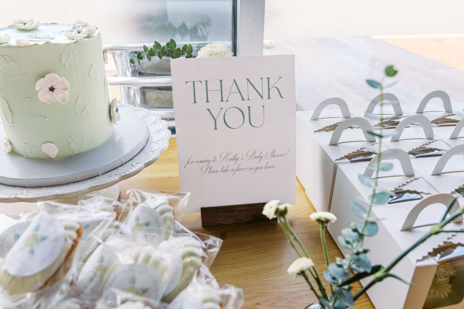Wedding reception details with thank you cards and delicate floral decorations.