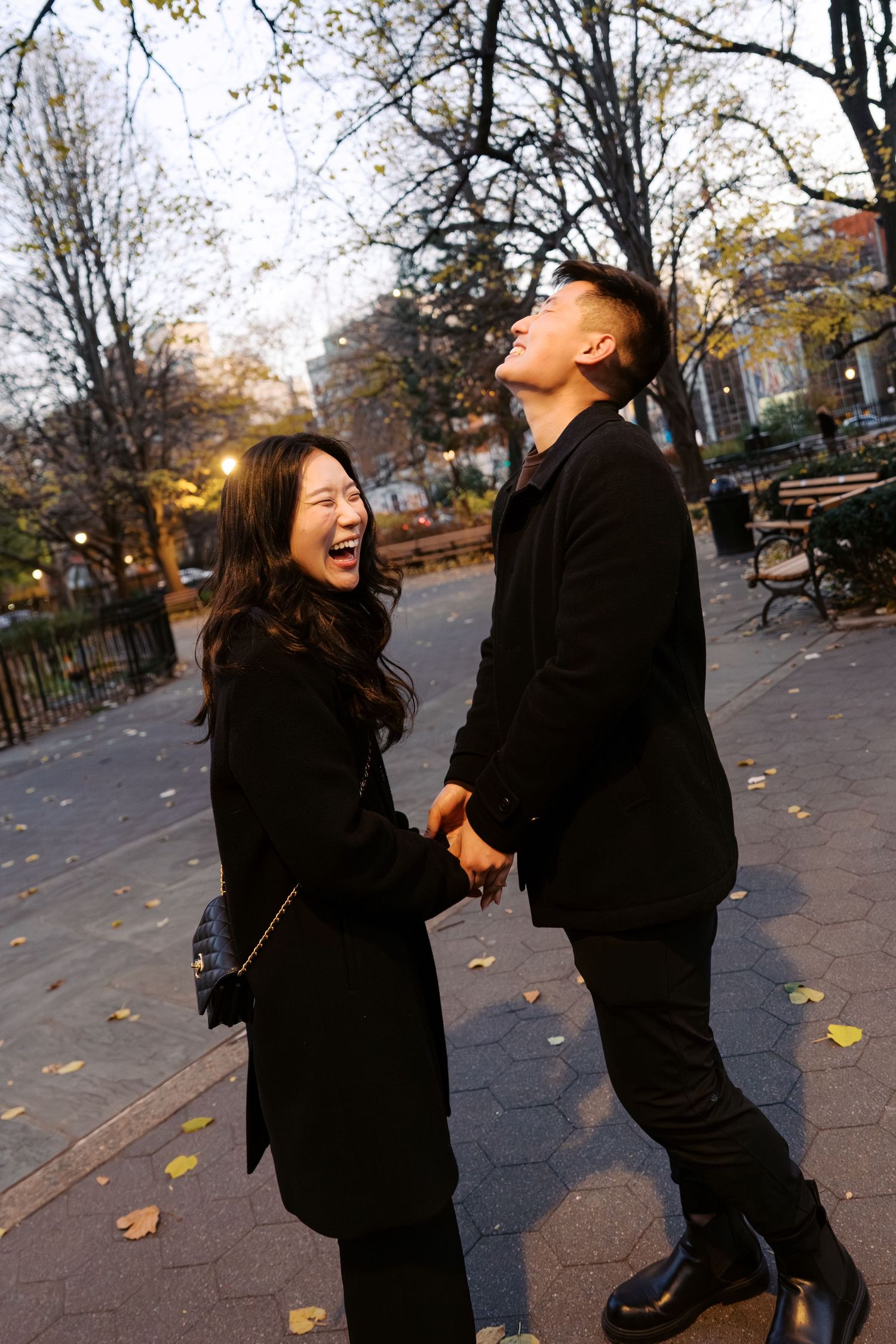 Couple enjoying a playful moment together on an autumn day in the park.