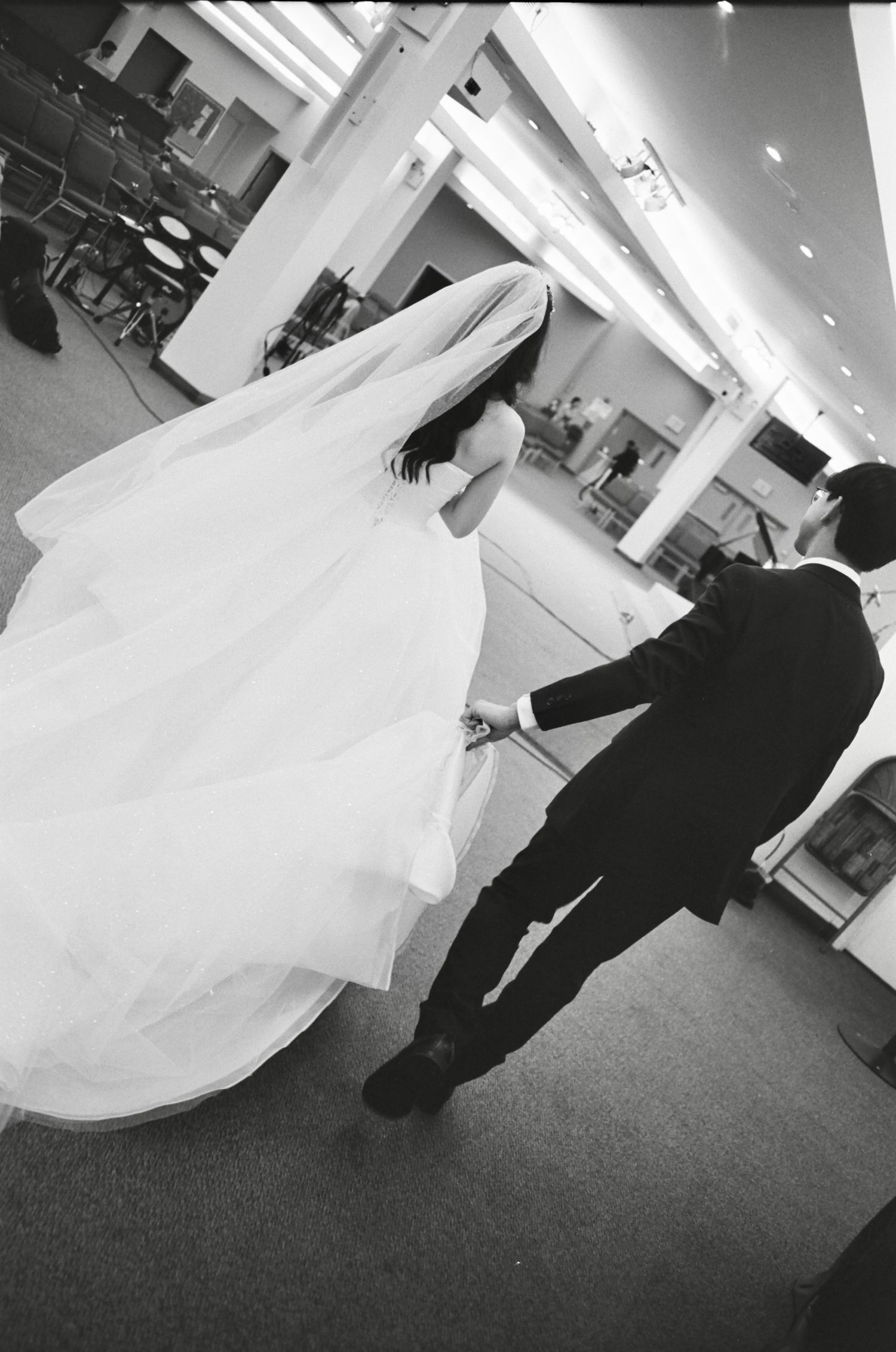 Black and white photos showing flowing wedding dress movements across a carpeted floor.