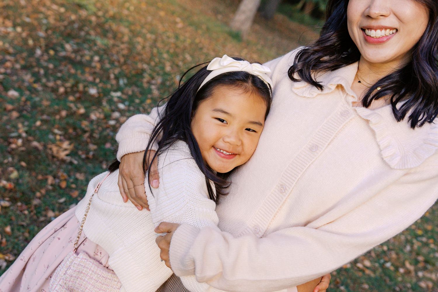 Warm embrace shared between two people in matching cream sweaters.