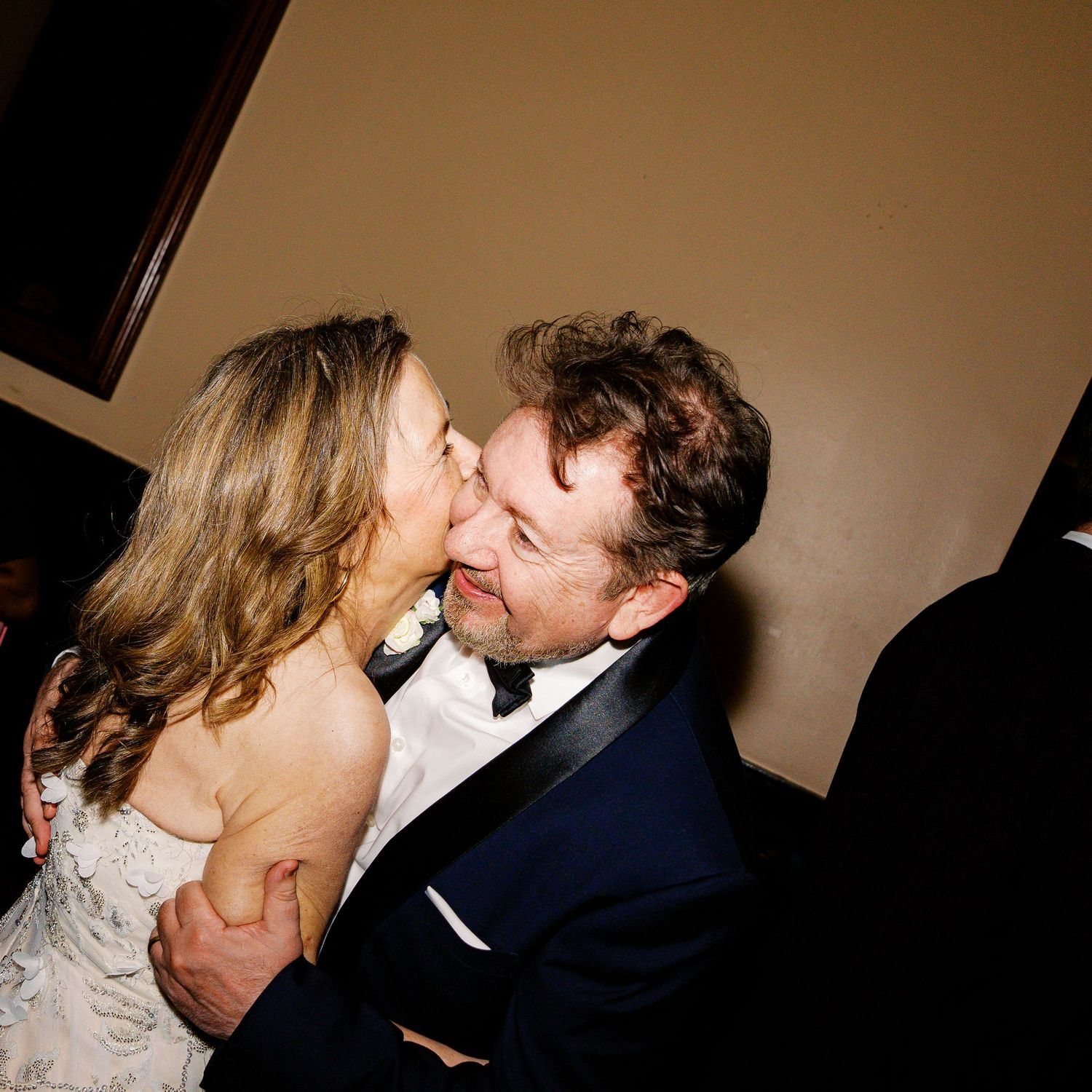 Romantic moment between newlyweds during their wedding reception.