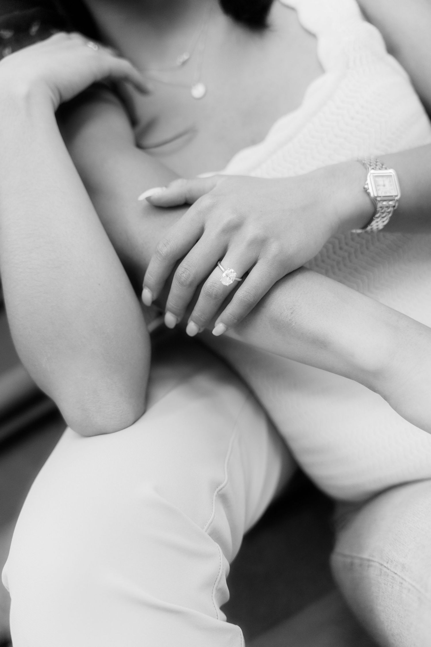 Close-up details of hands and white clothing in an intimate black and white photo series.