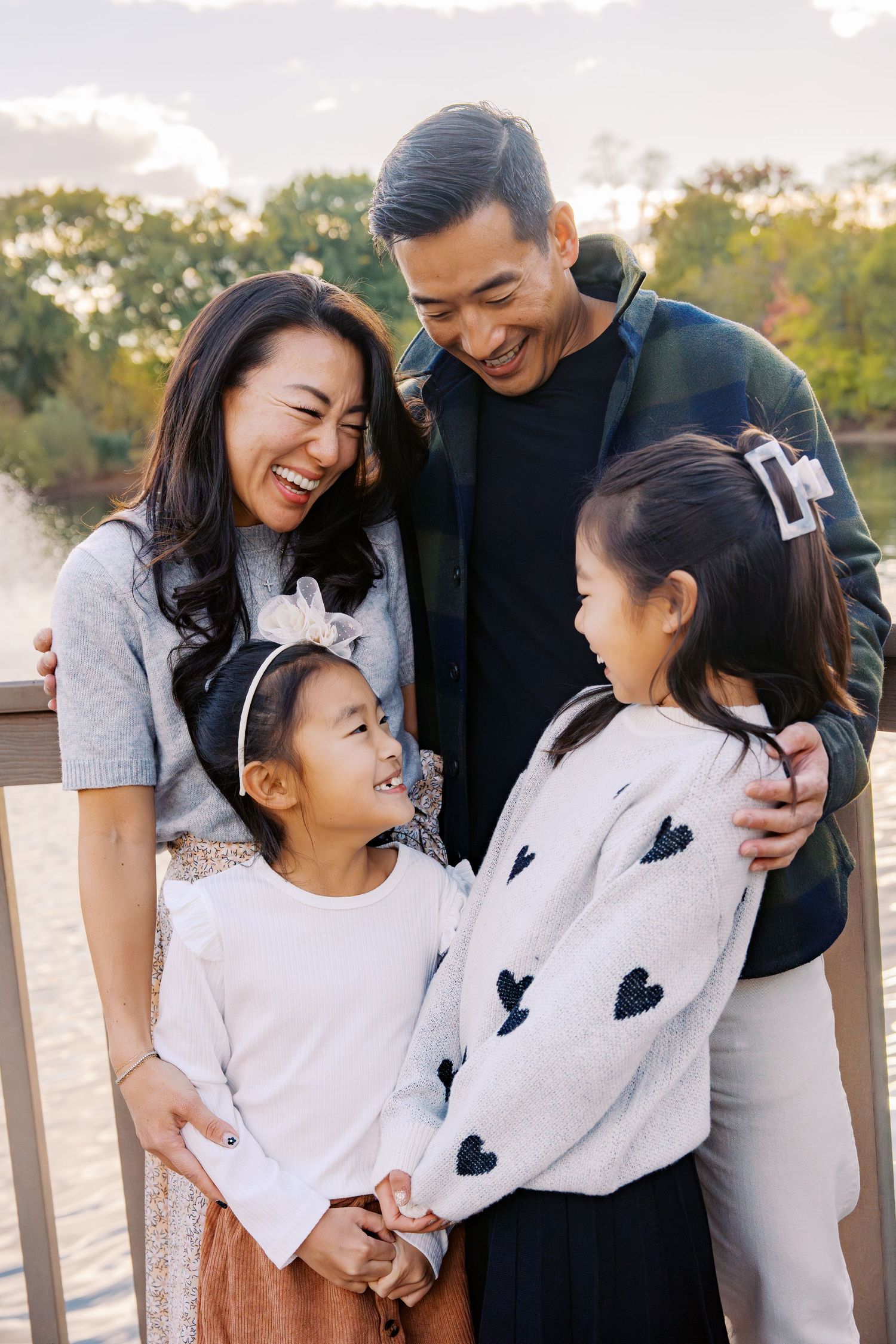 Family sharing tender moments together while wearing coordinated outfits.