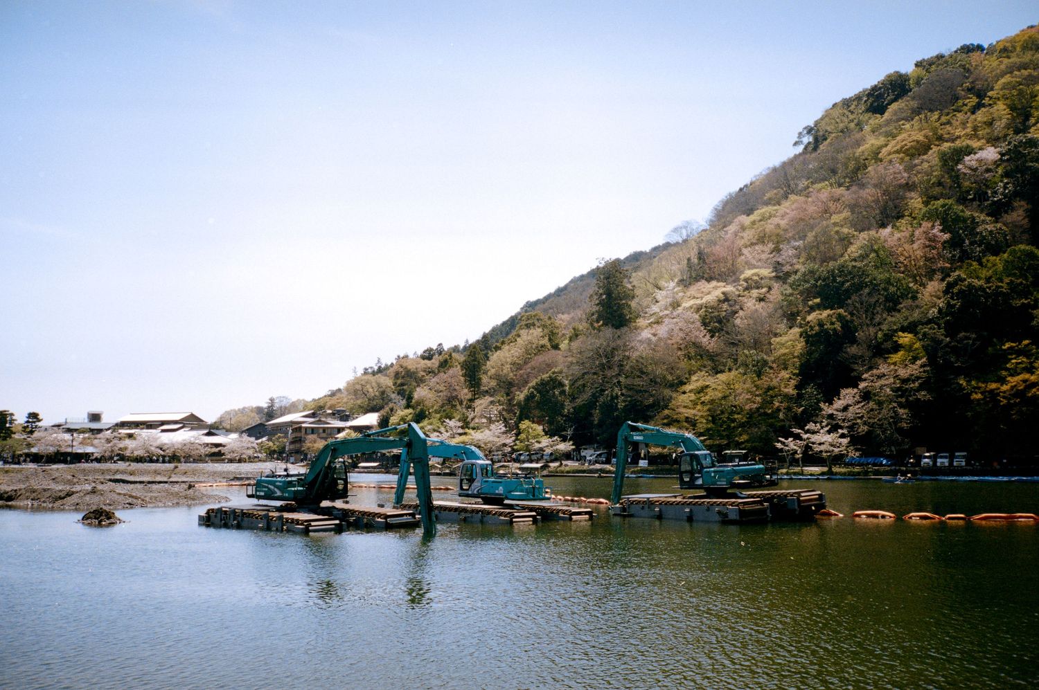 Panoramic view of a lake surrounded by mountains and boat docks.