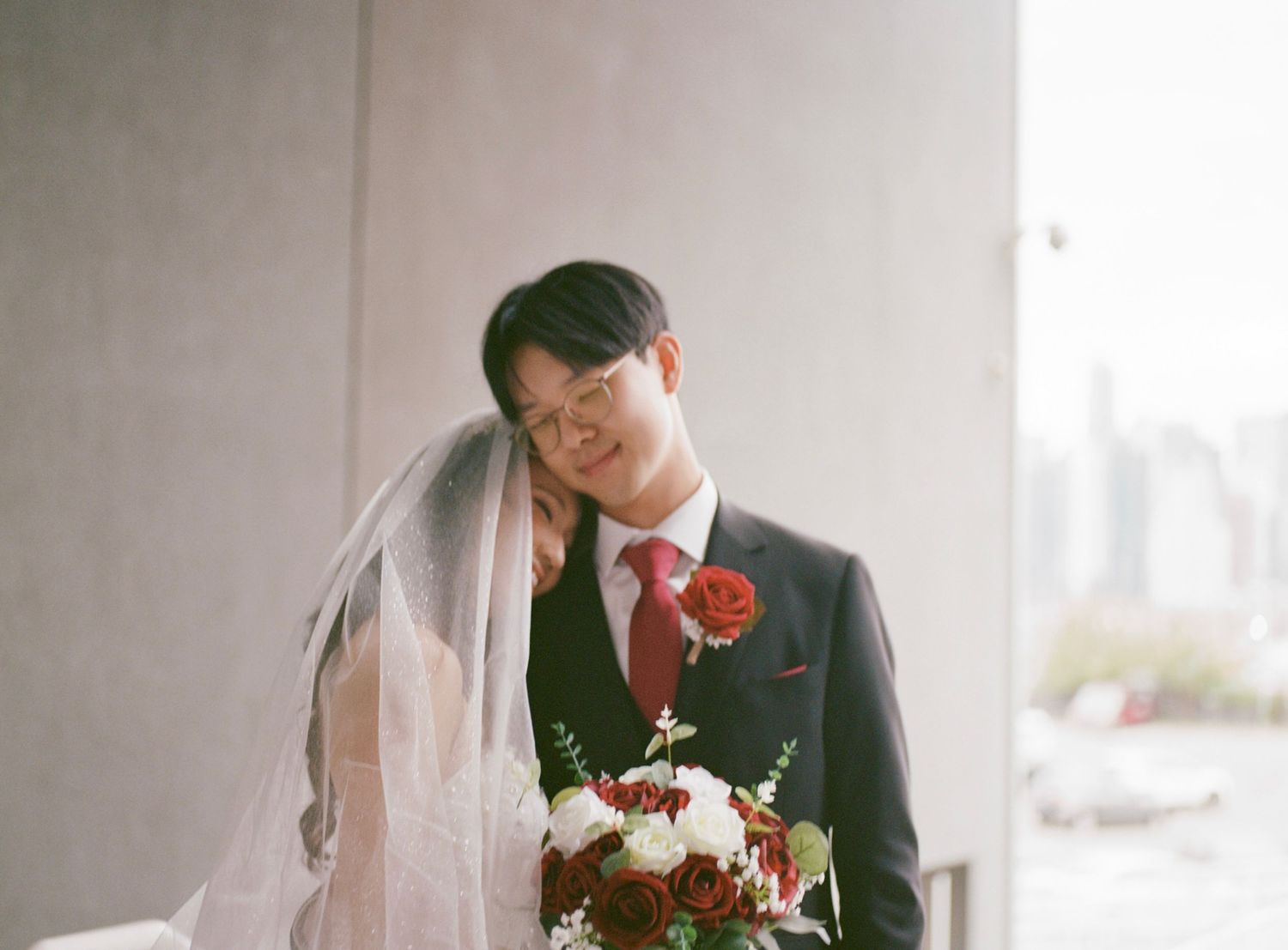 Couple in formal wedding attire sharing an intimate moment.
