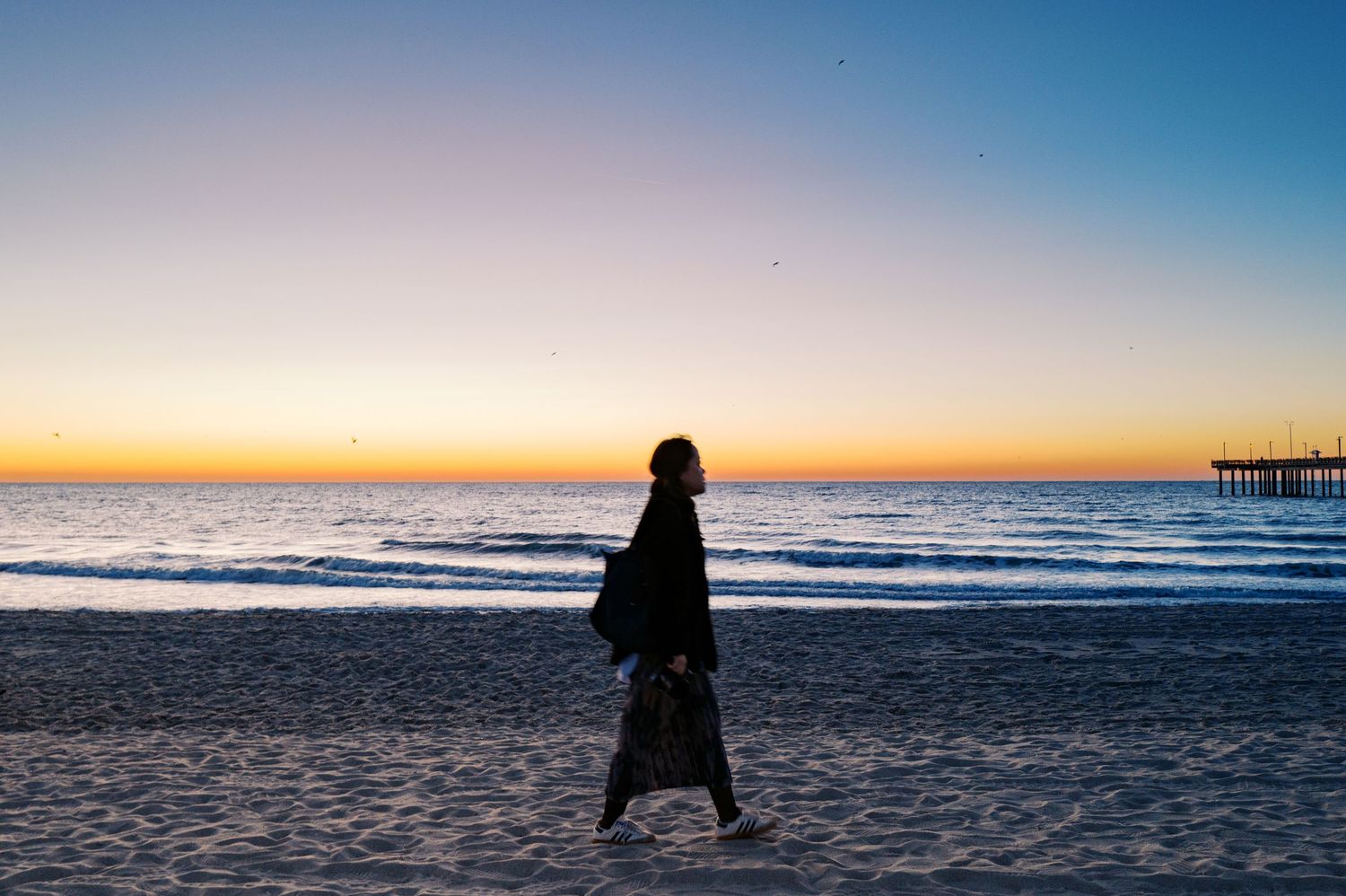 A series of serene beach sunset photos showing waves, silhouettes, and coastal views along the shoreline.