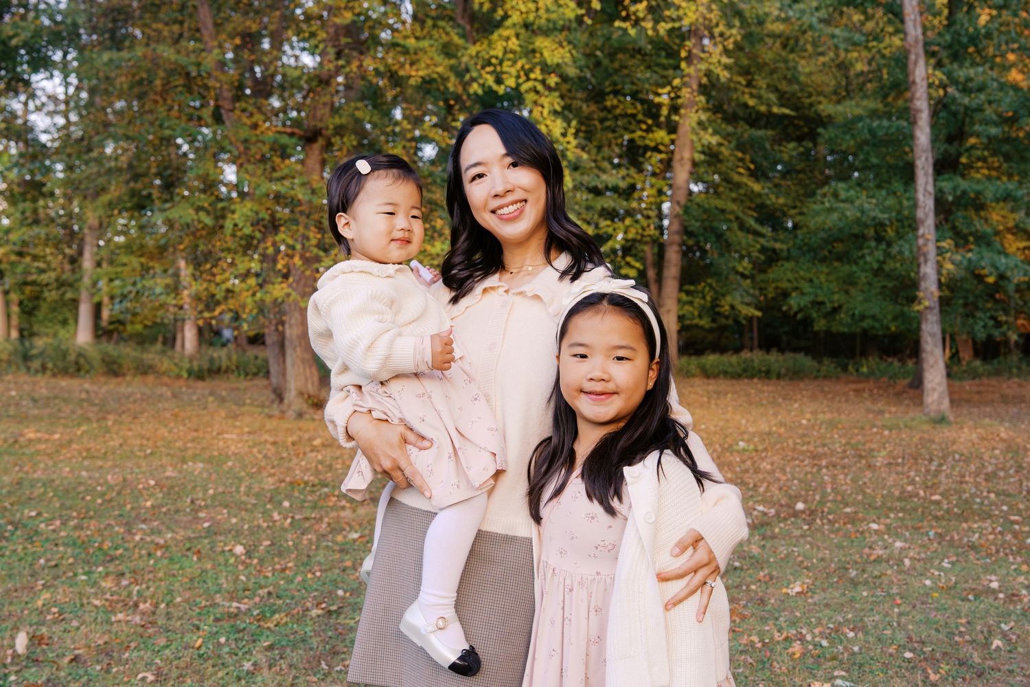 Outdoor family portrait in soft neutral colors during autumn.