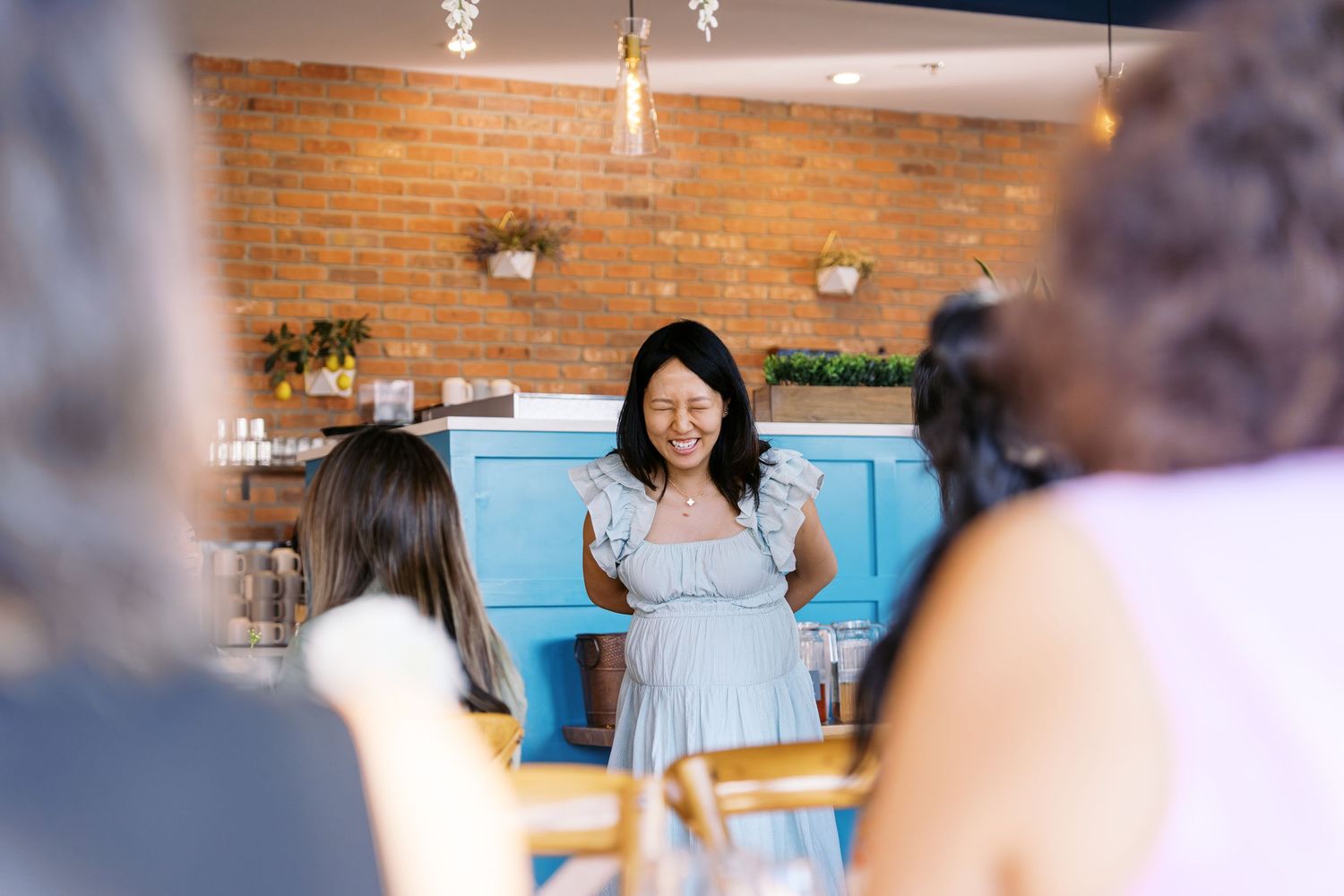 Indoor celebration space with exposed brick walls and modern lighting fixtures.