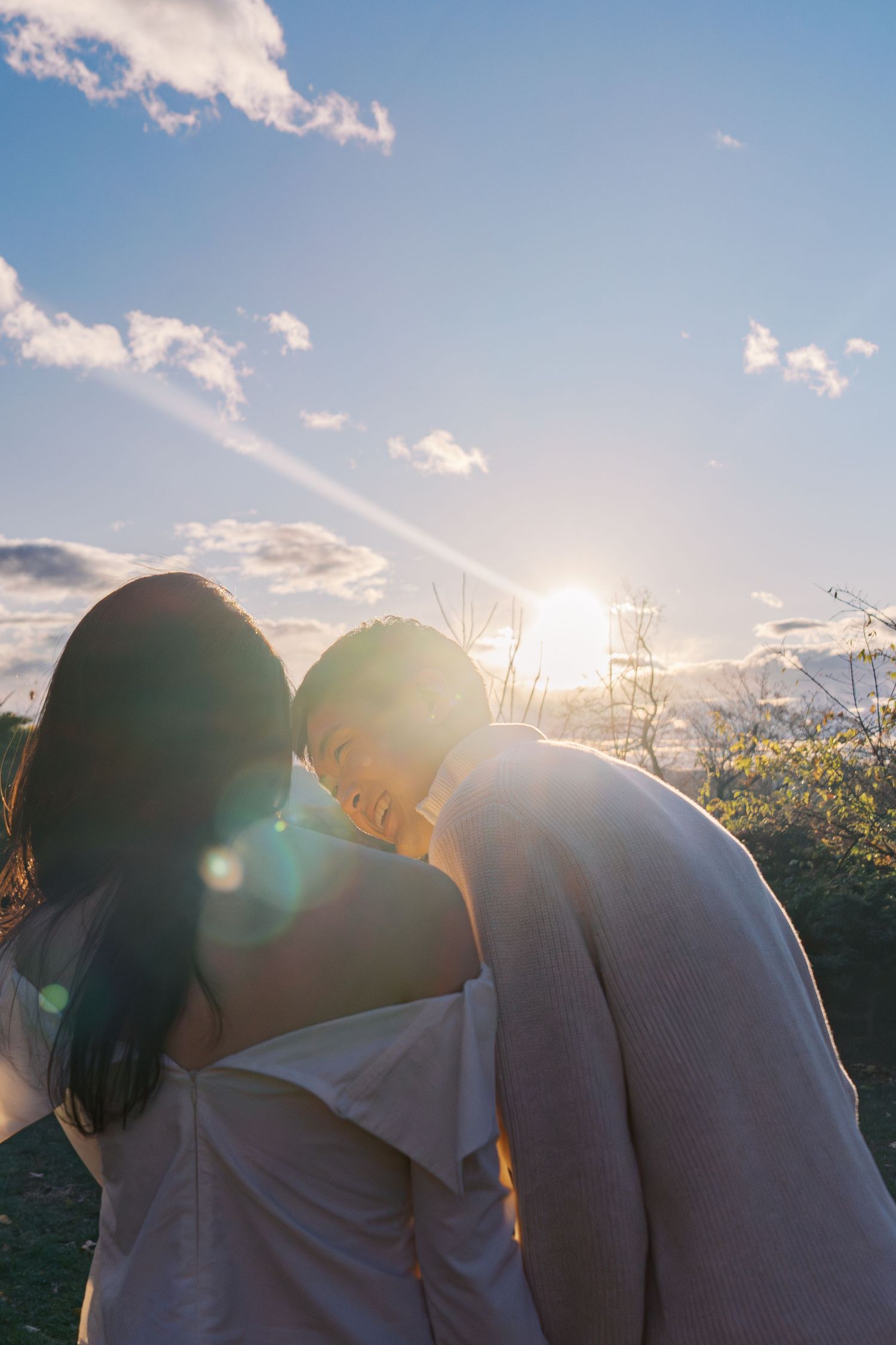 Intimate silhouette of a couple sharing a tender moment in golden sunlight.