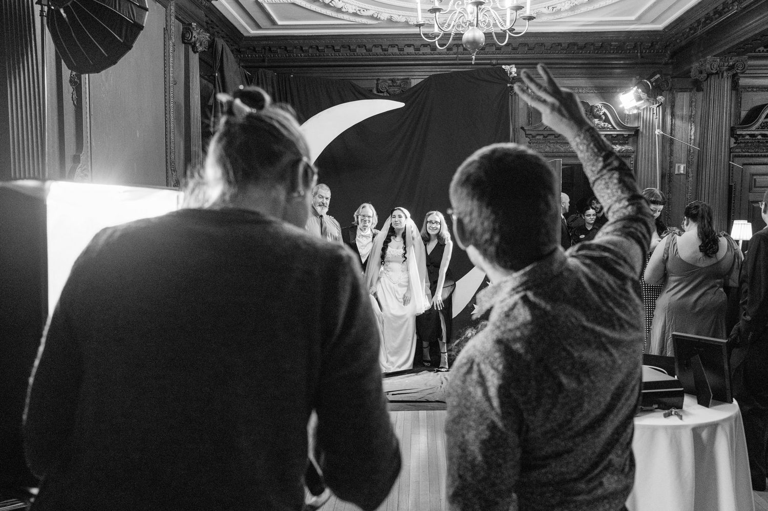 Black and white wedding reception photos showing dancing and celebration under elegant chandeliers.