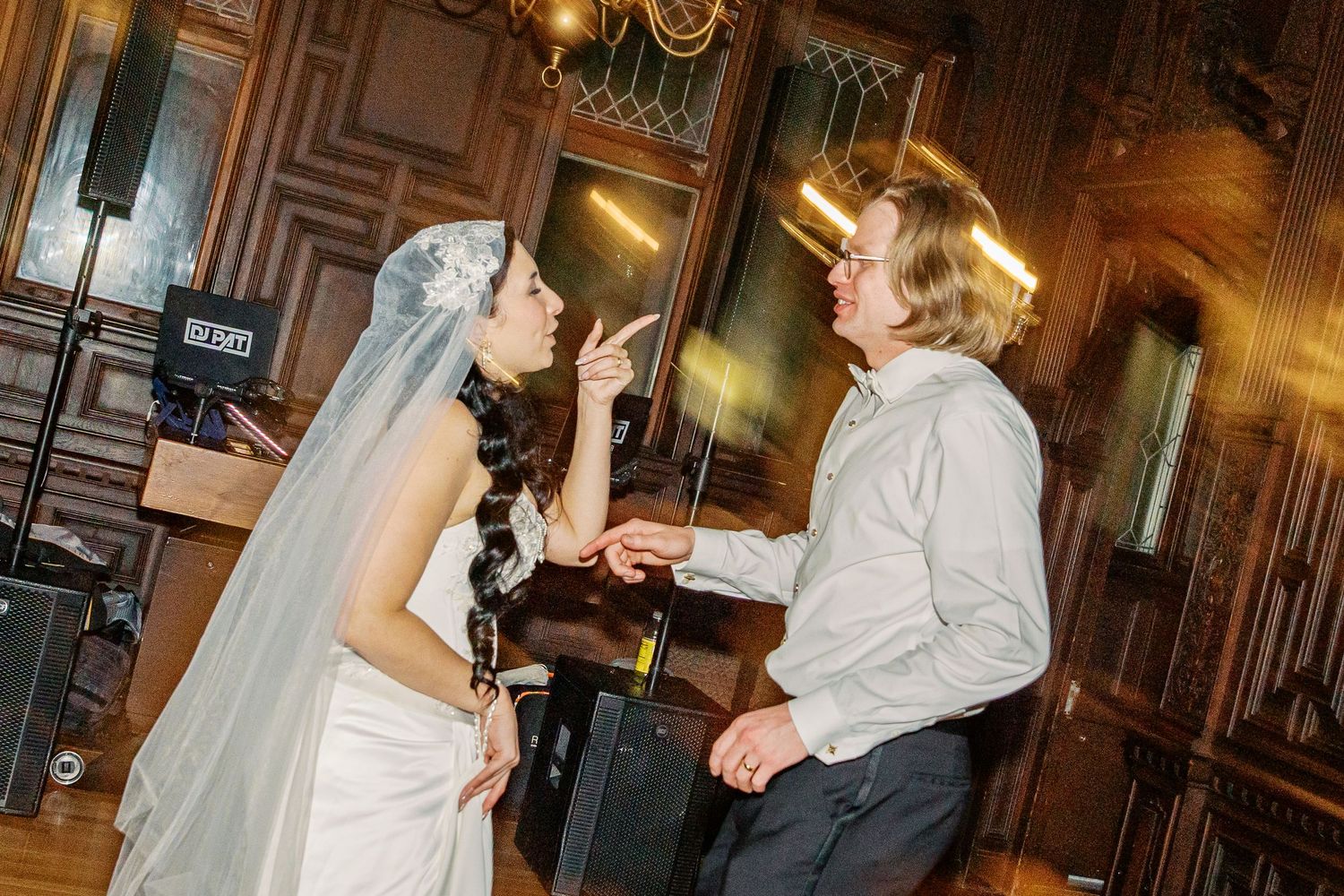 A series of black and white photographs showing people dancing and celebrating at an elegant indoor venue.