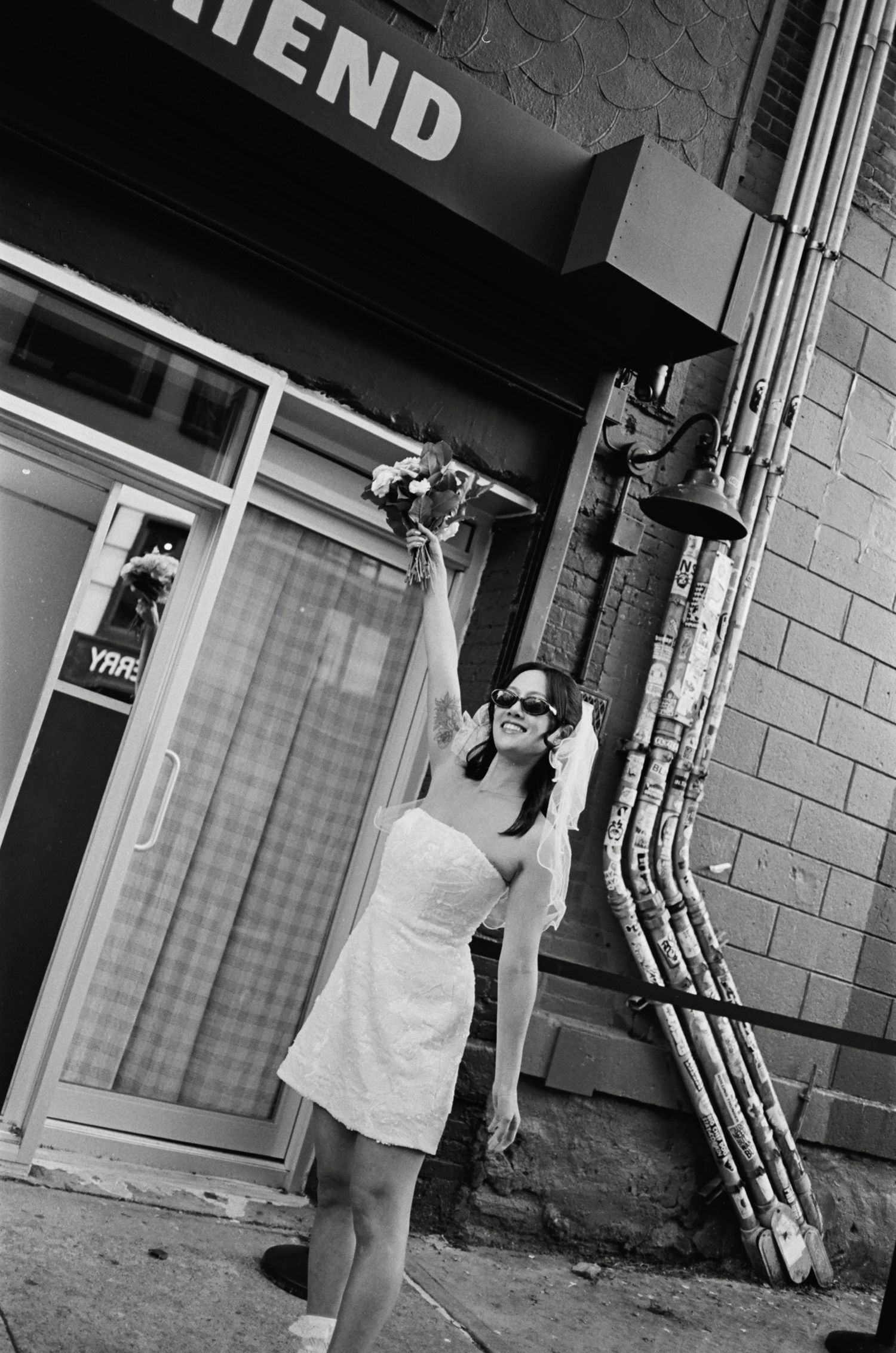 Series of black and white images outside a storefront with 'FRIEND' signage.
