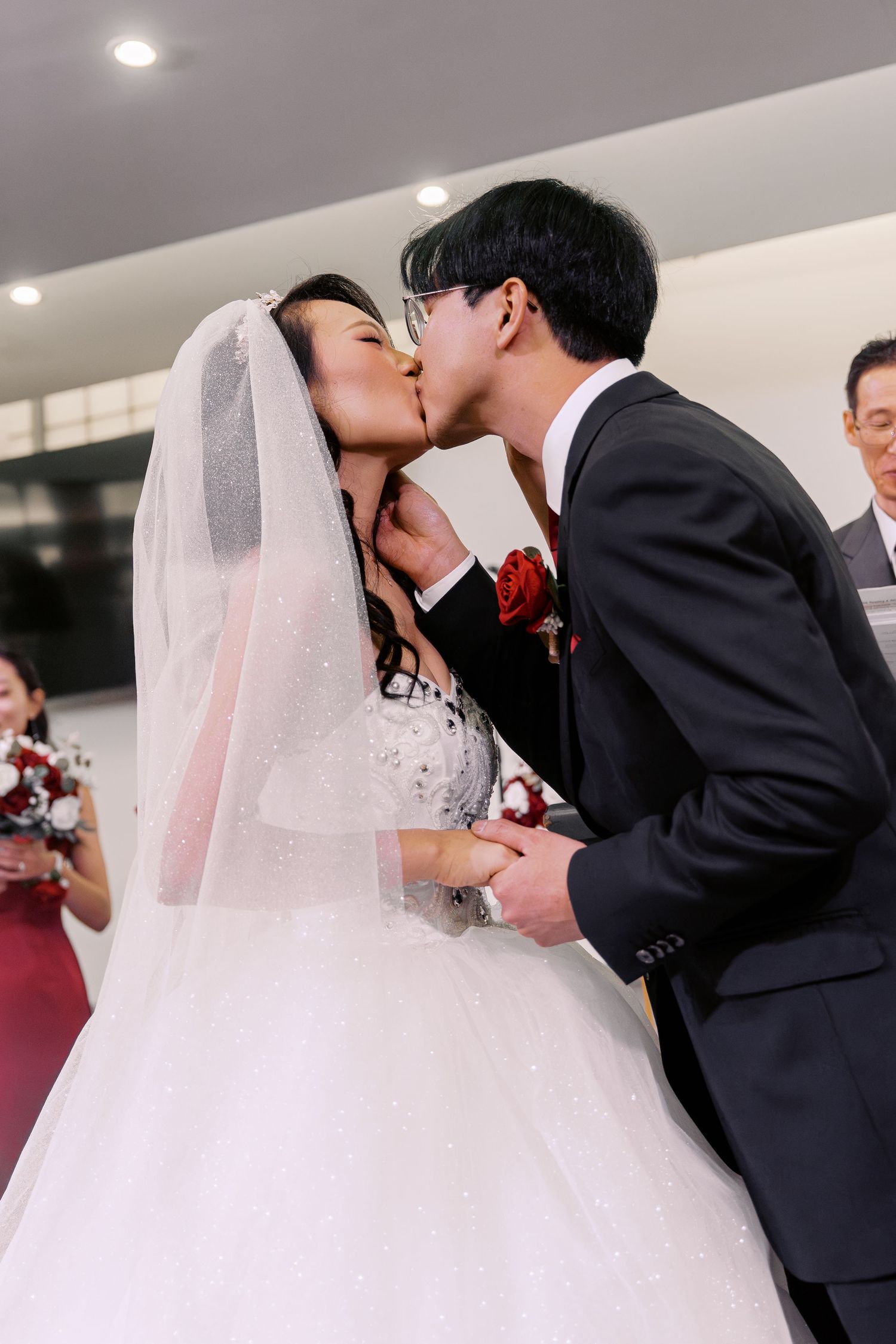 First kiss as newlyweds during wedding ceremony.