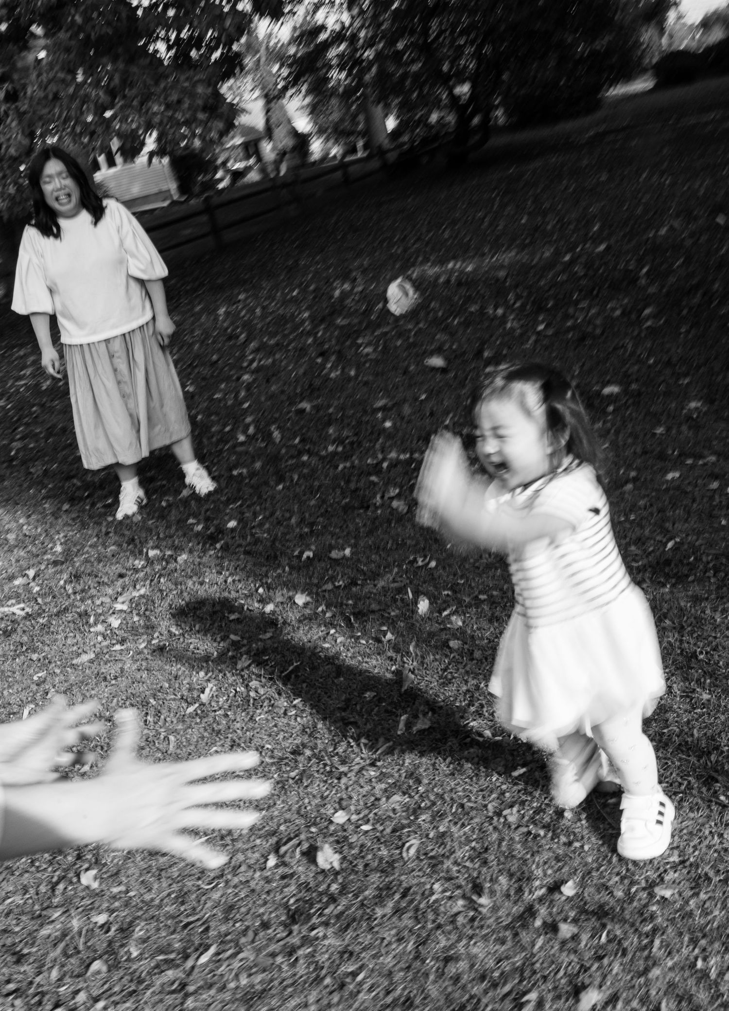 Black and white photo of playful moment in a park.