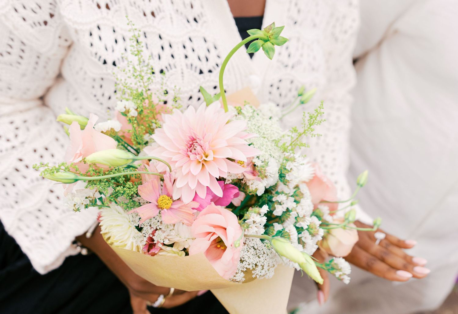 Delicate pink and white floral arrangements with baby's breath create a romantic setting.