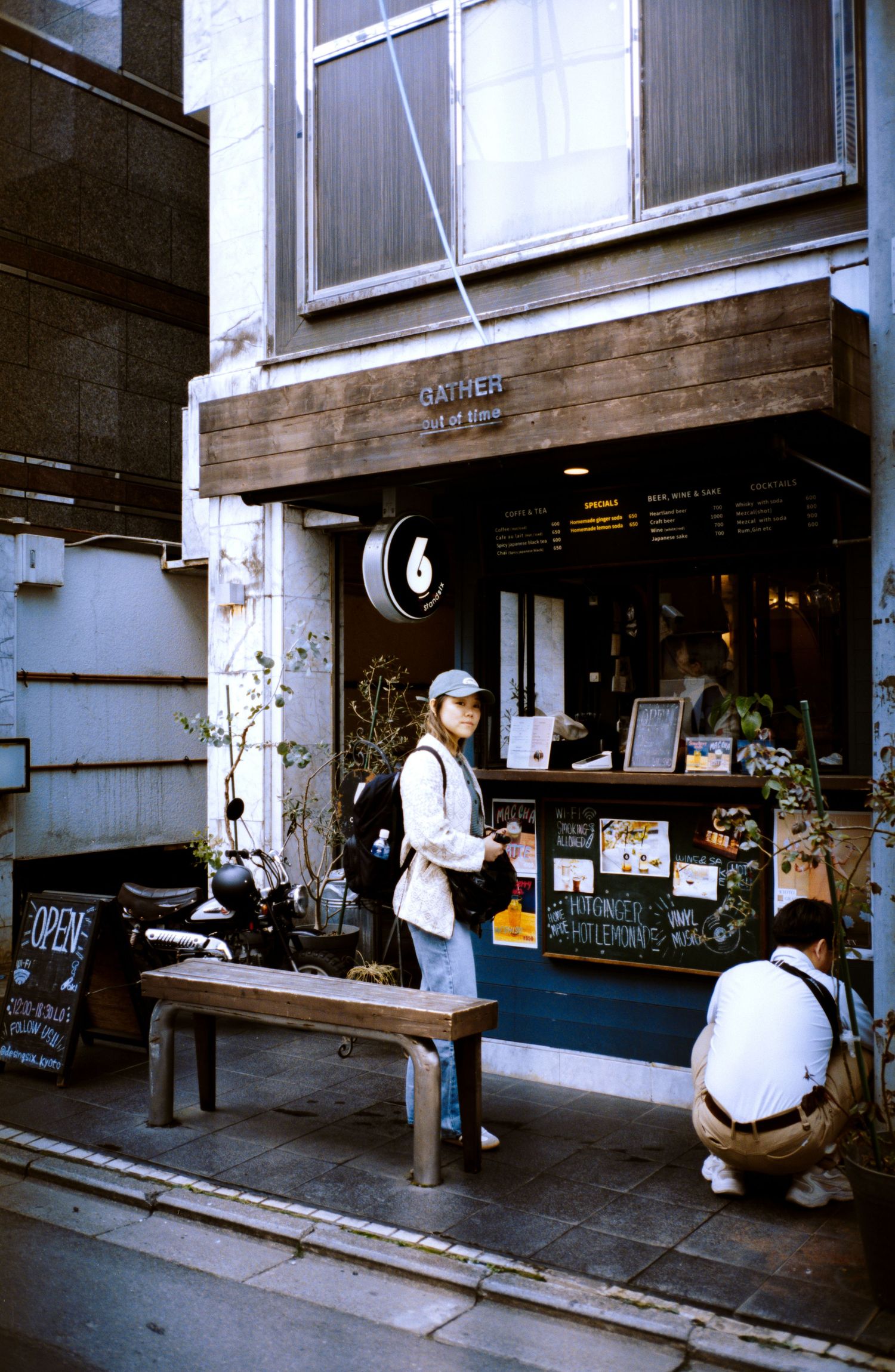 A small coffee shop storefront in Japan with outdoor seating and minimalist design.