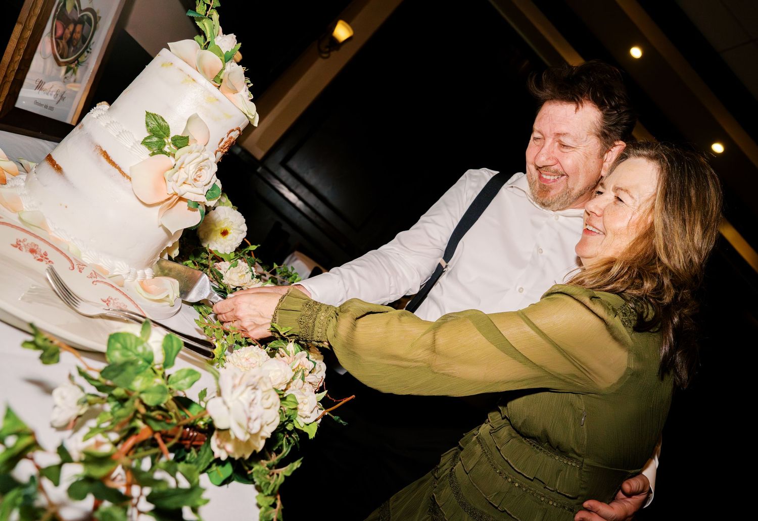 Couples sharing joyful dance moves at an evening celebration.