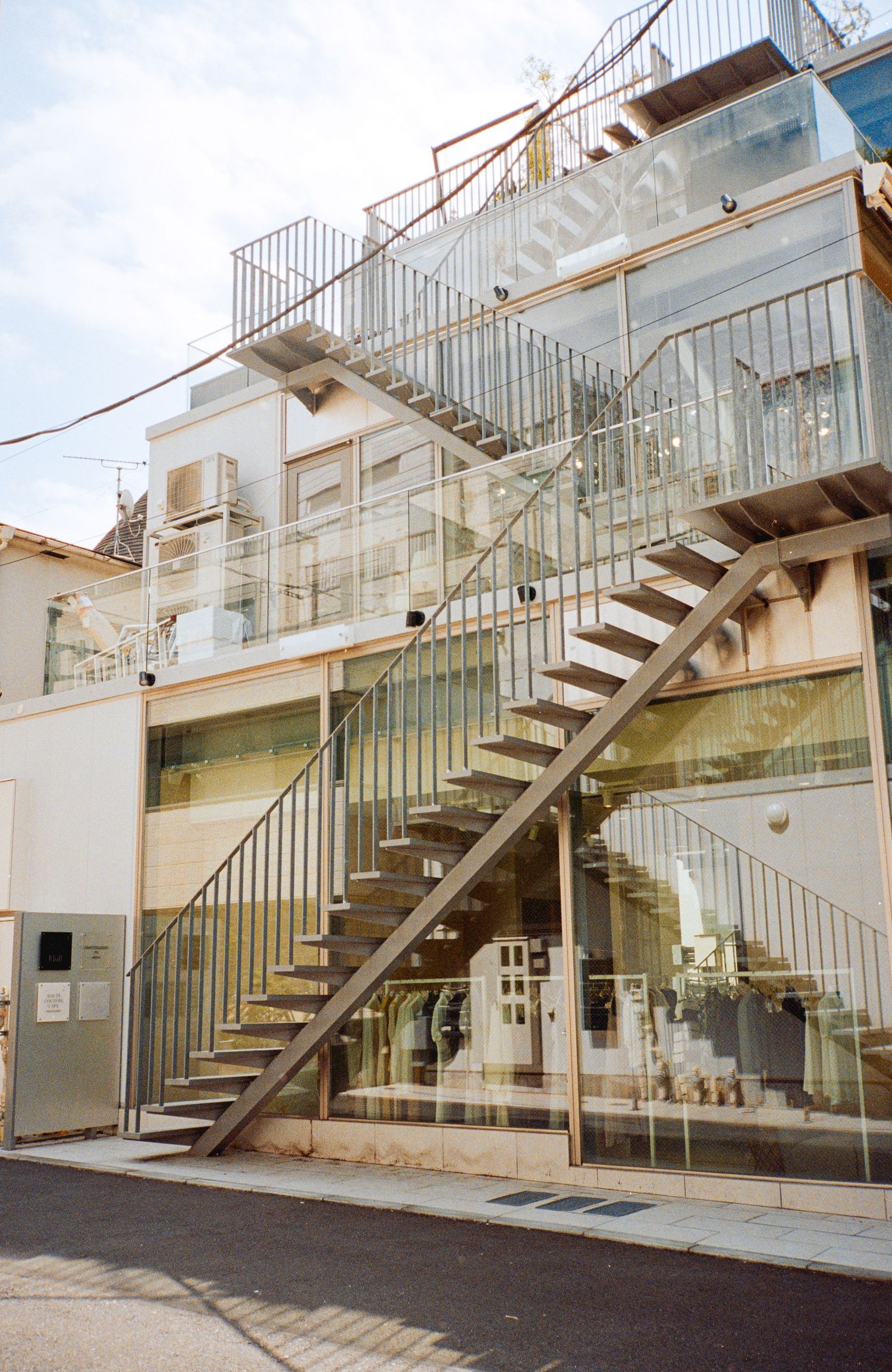 Modern glass and metal staircase structure with clean architectural lines.
