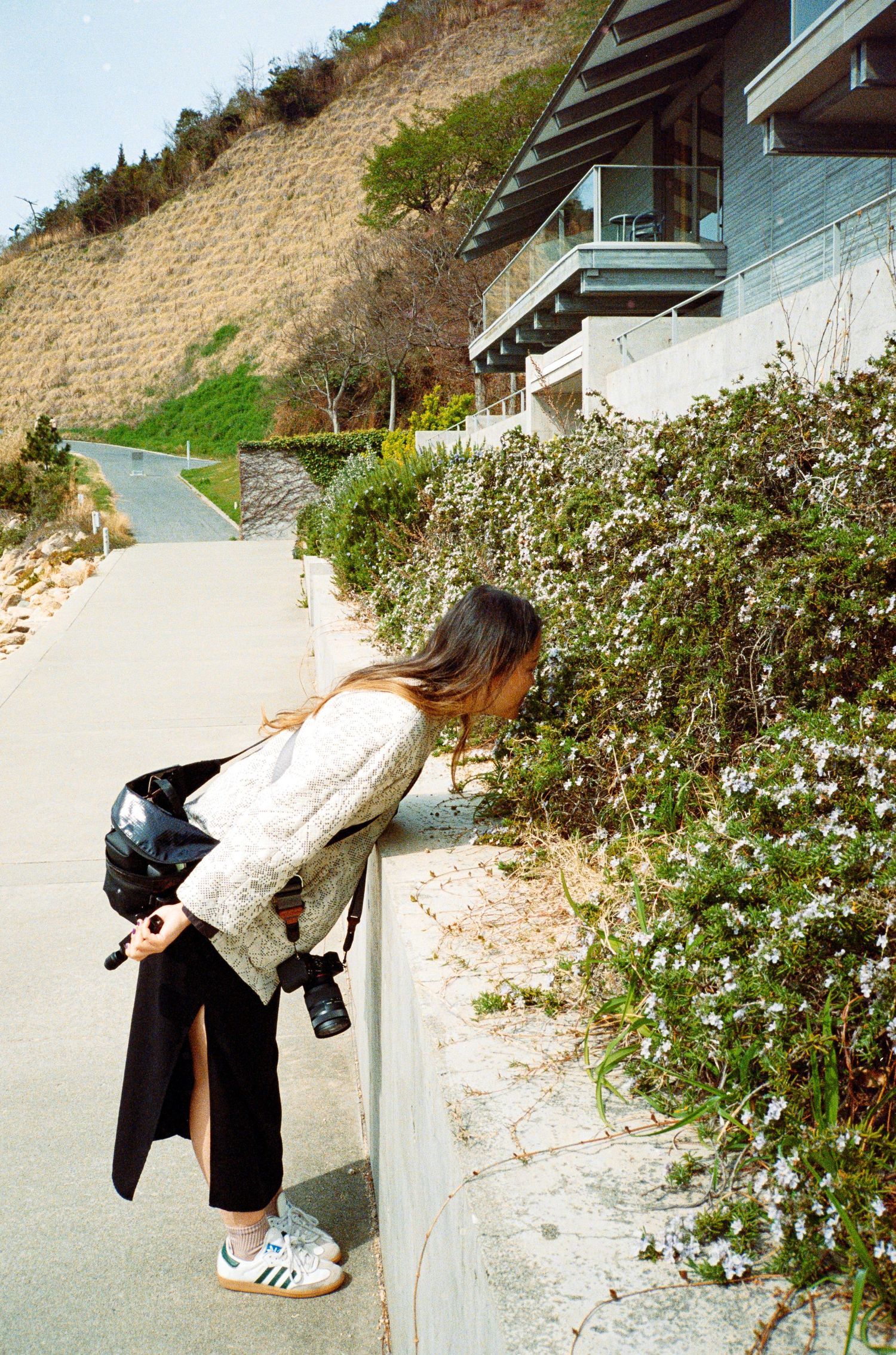 Sequential shots showing bending movement against a coastal cliff background.