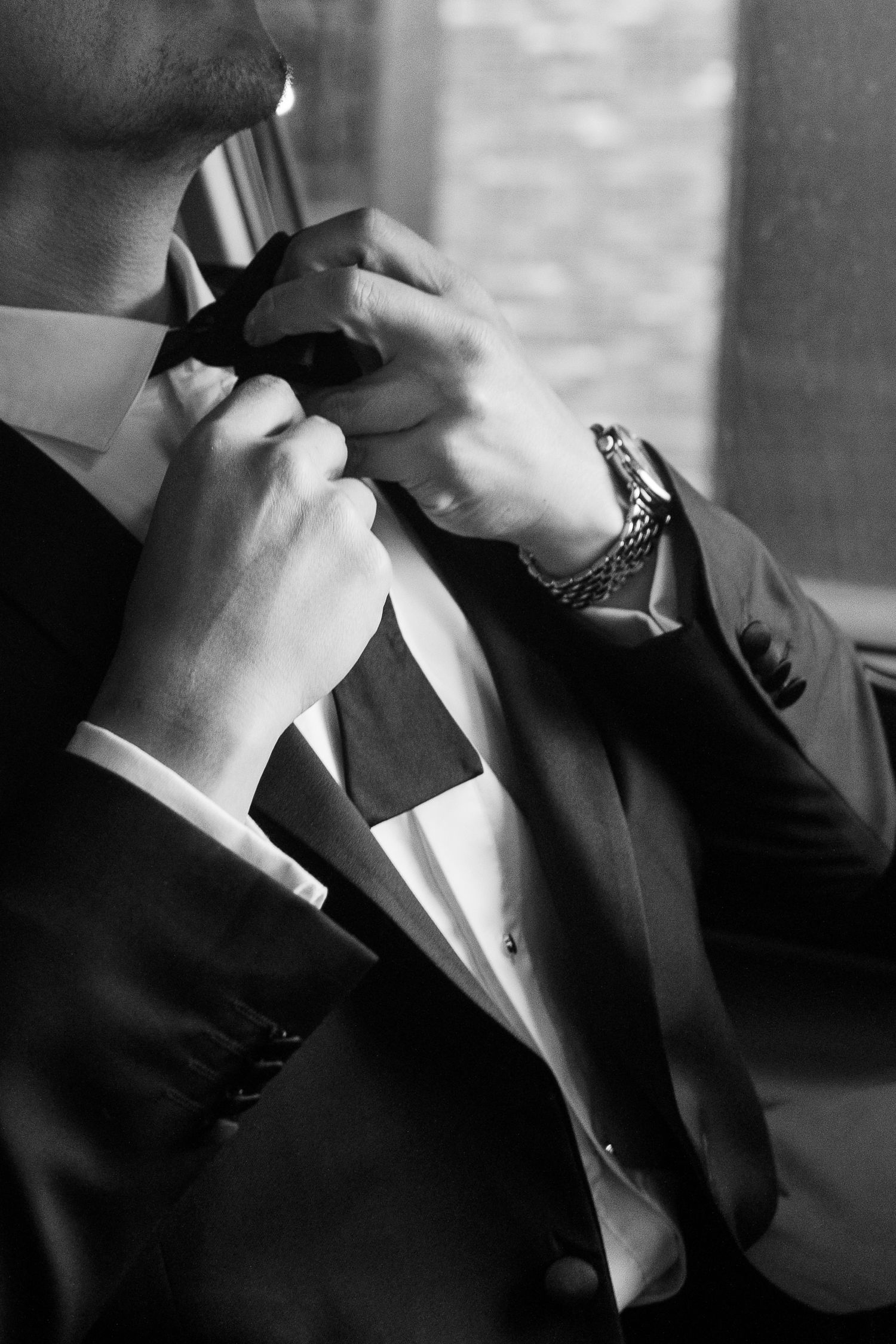 A black and white sequence showing hands tearing paper into pieces in dramatic lighting.