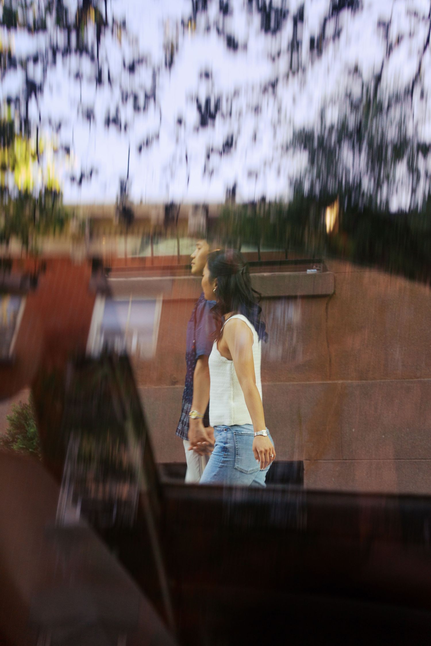 Blurred motion sequence showing movement across a brick wall outdoors.