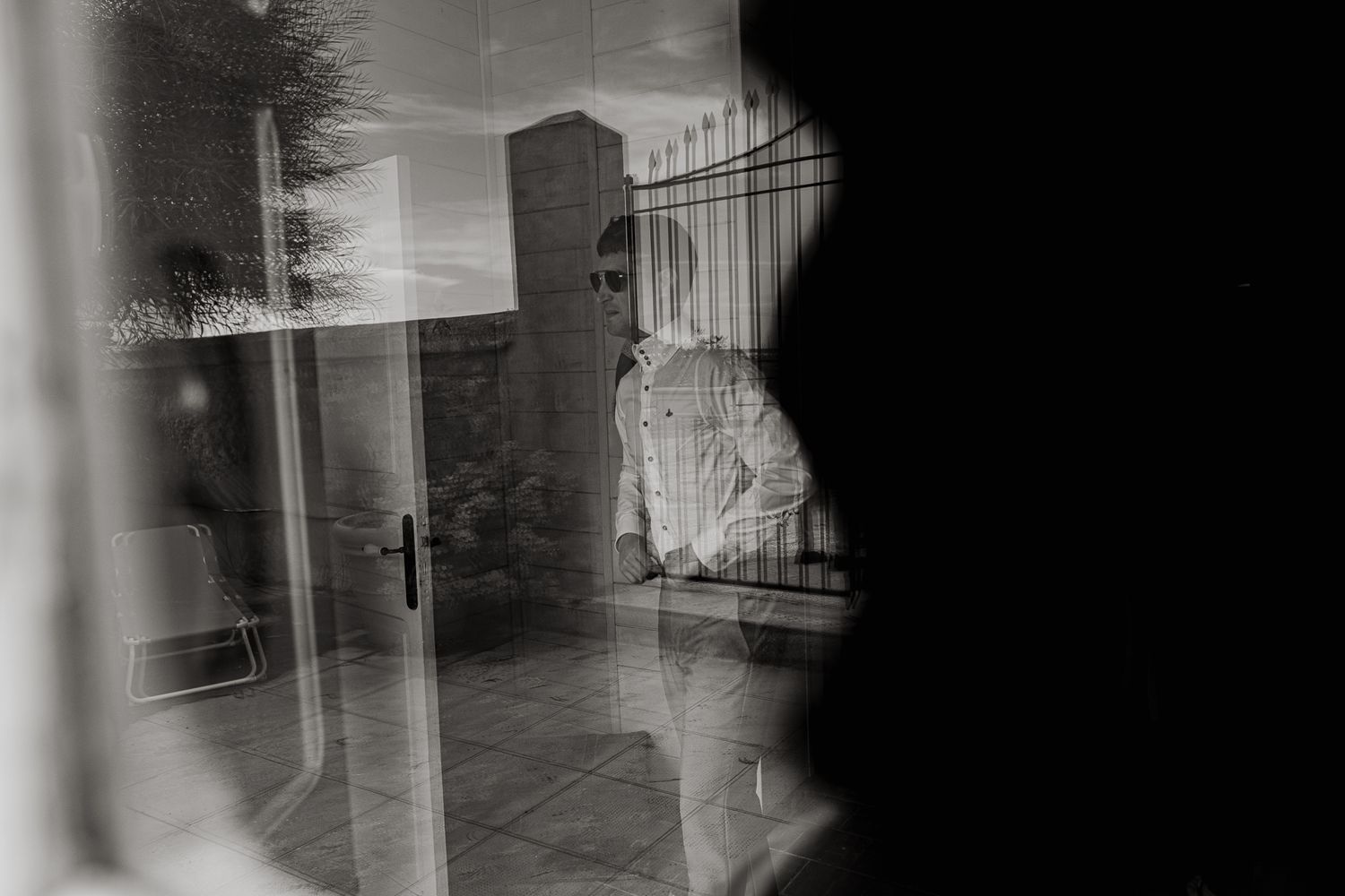 Artistic black and white reflection through window with architectural elements. Sicily wedding. Palermo. Siracusa. Scopello.