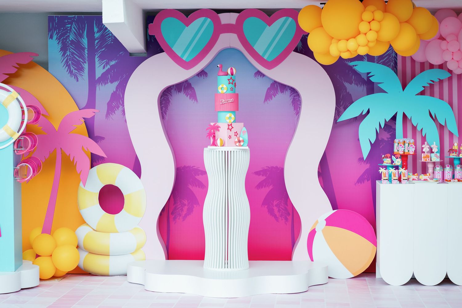 Vibrant party backdrop with heart shapes, palm trees, and castle design in pink and turquoise.
