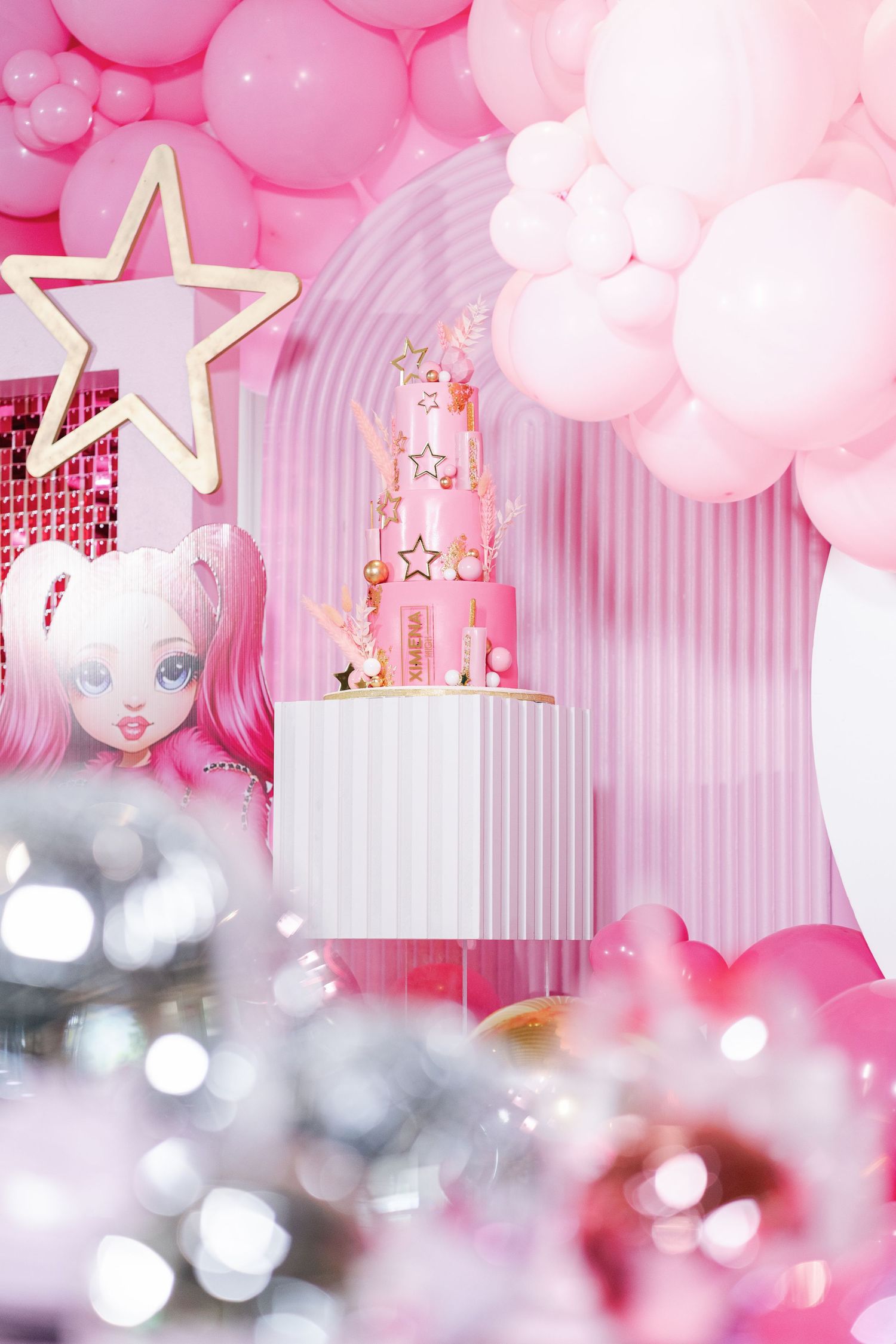 Pink and white party decor with balloons, stars, and dreamy lighting creating a magical atmosphere.