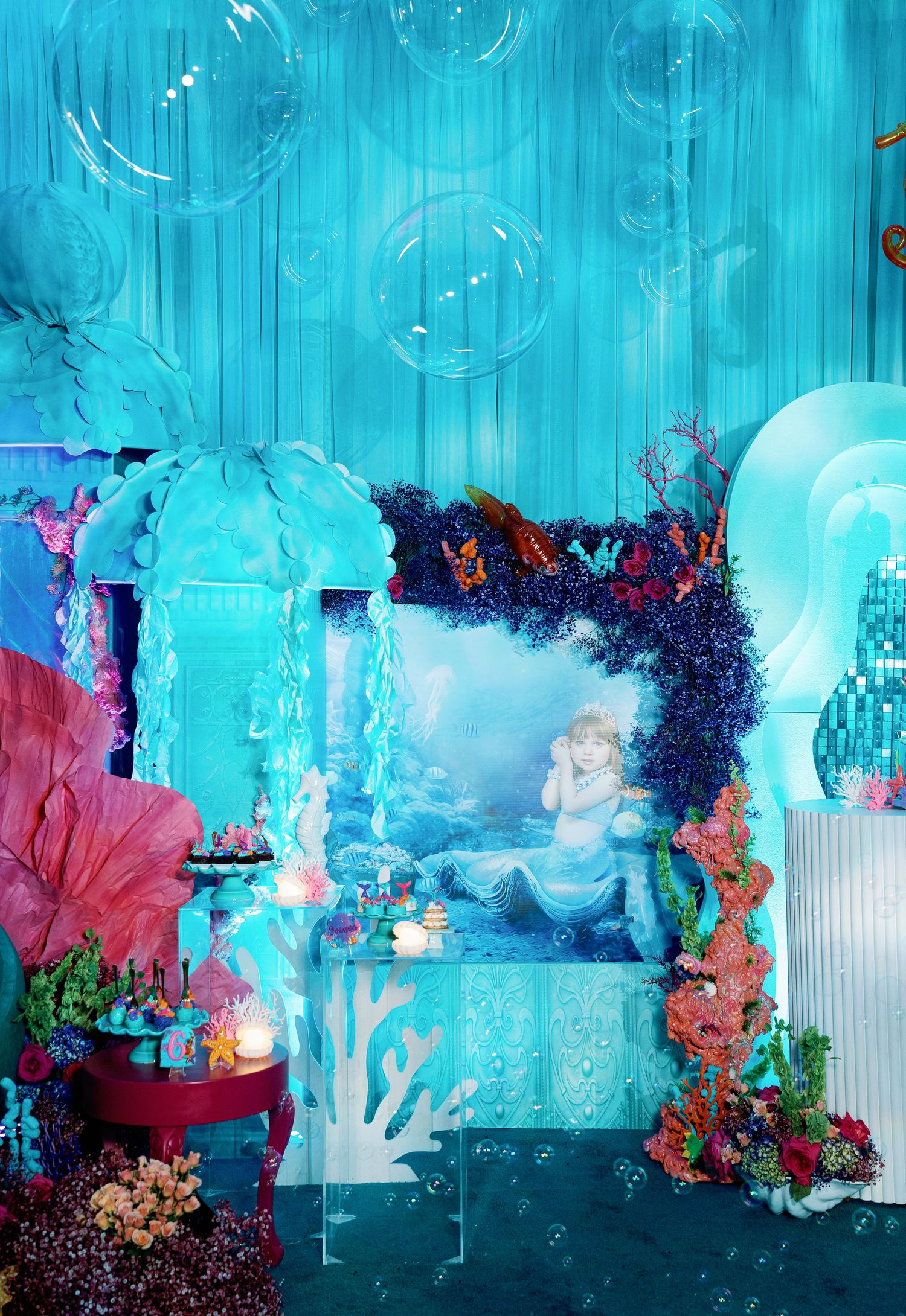 Magical underwater scene backdrop with turquoise lighting and floating bubble effects for special events.