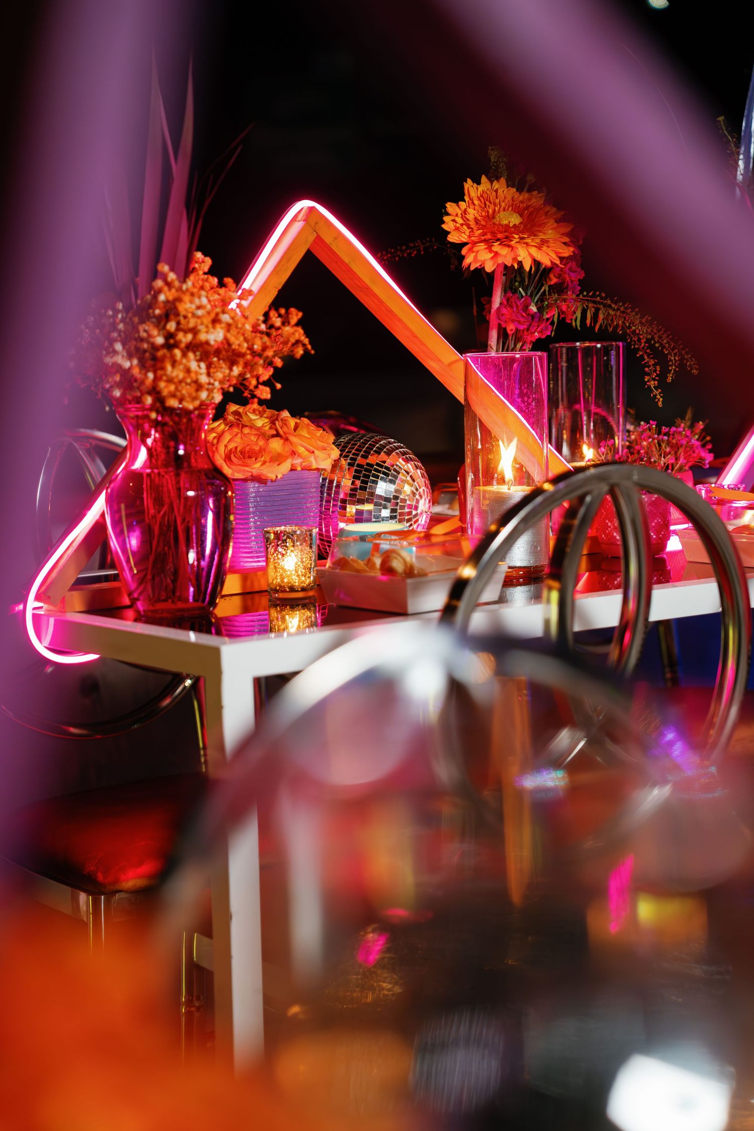 Dramatic event lighting setup with orange and pink hues creating a vibrant atmosphere.