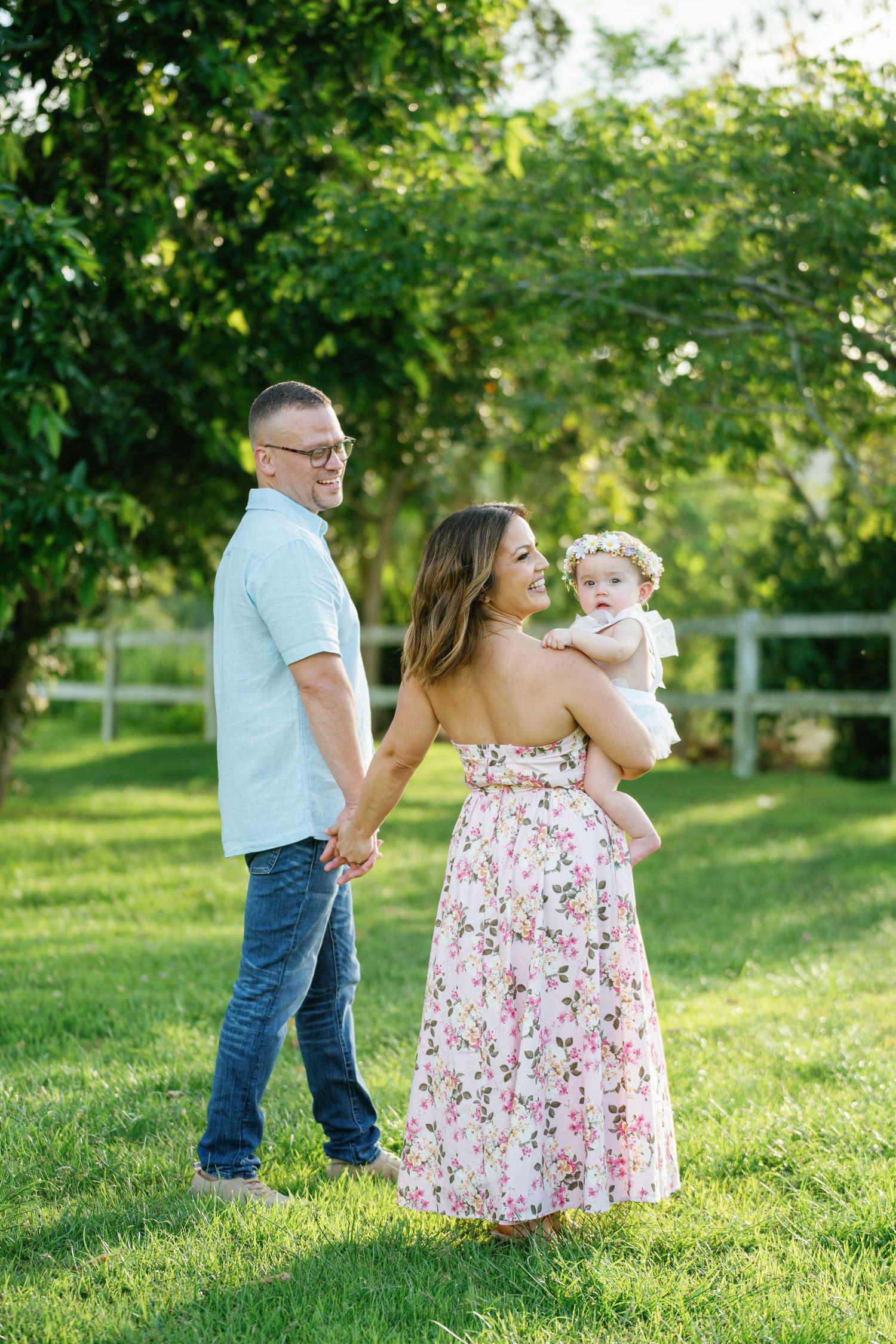 Family enjoying sunny day together in green garden setting.
