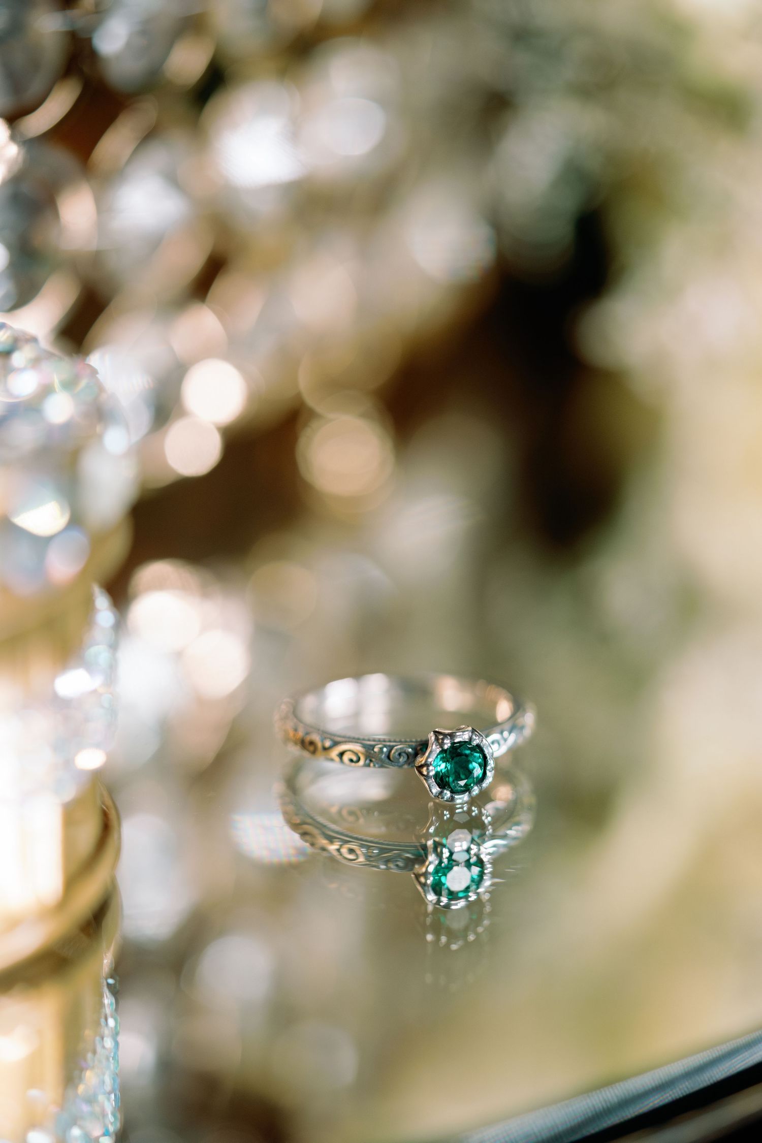 Close-up of a delicate turquoise engagement ring with diamond accents in soft focus.