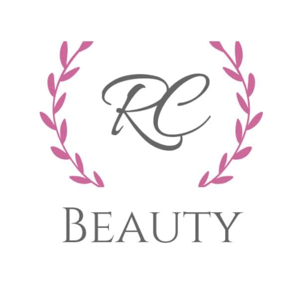 RC Beauty logo with elegant script lettering framed by pink laurel branches on white background.