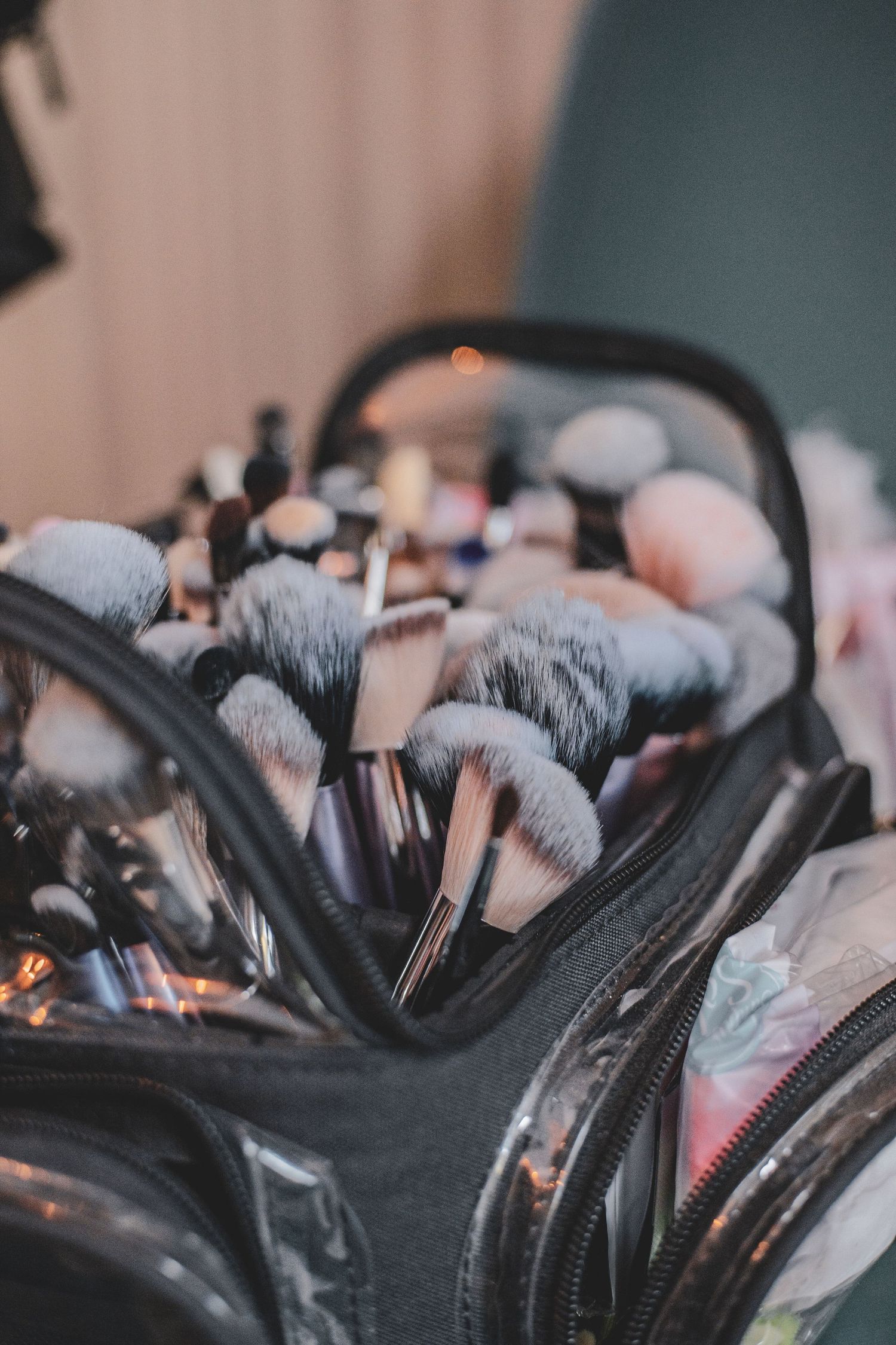 Professional makeup artist kit with assorted brushes and cosmetics in open black travel case, business branding photoshoot/