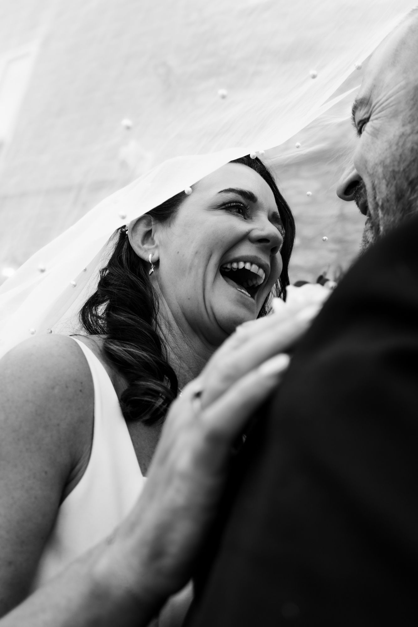 A black and white photo series showing a tender romantic moment between a couple sharing a kiss.