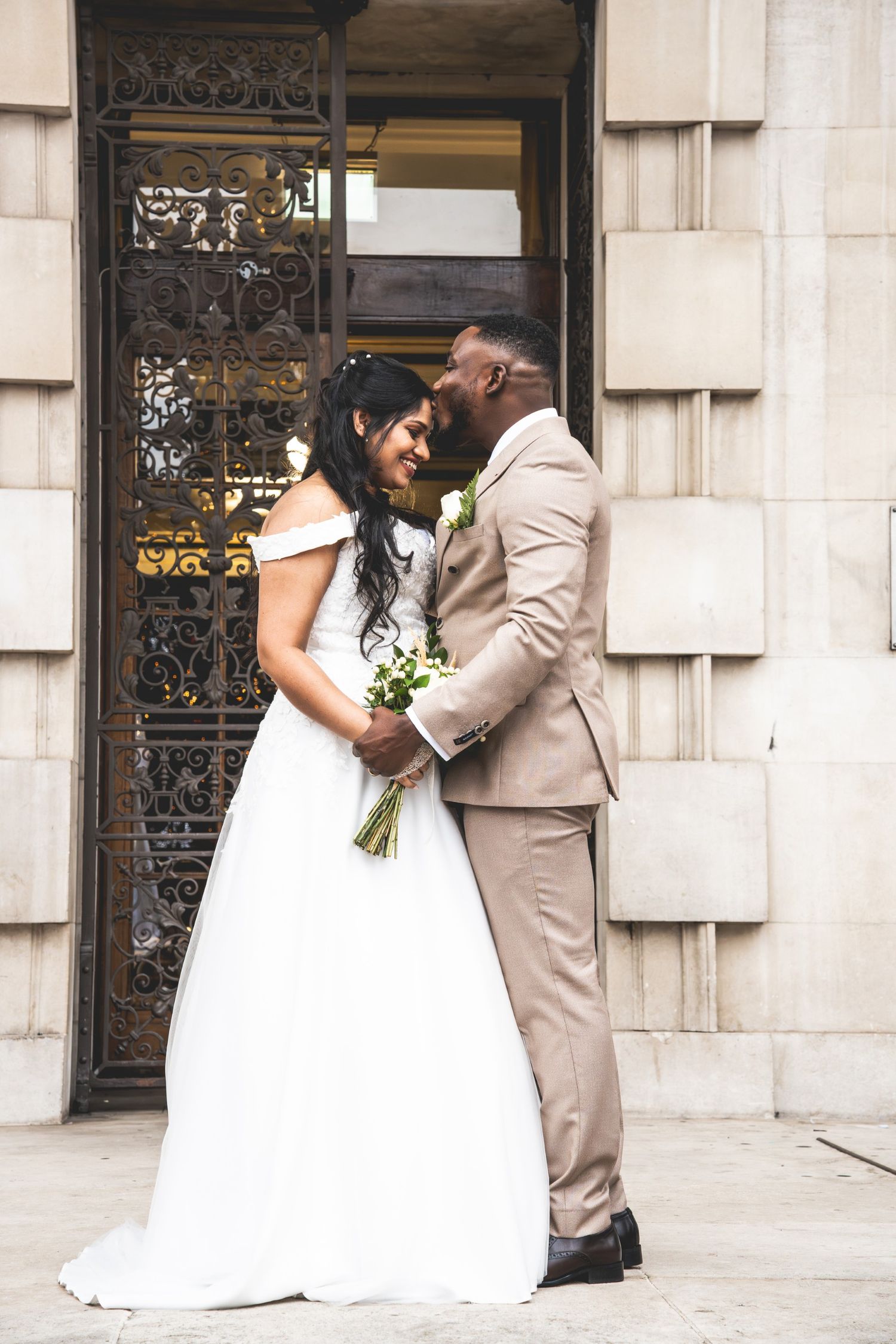 A sequence of wedding photos showing a couple in white dress and tan suit sharing romantic moments against a stone building.