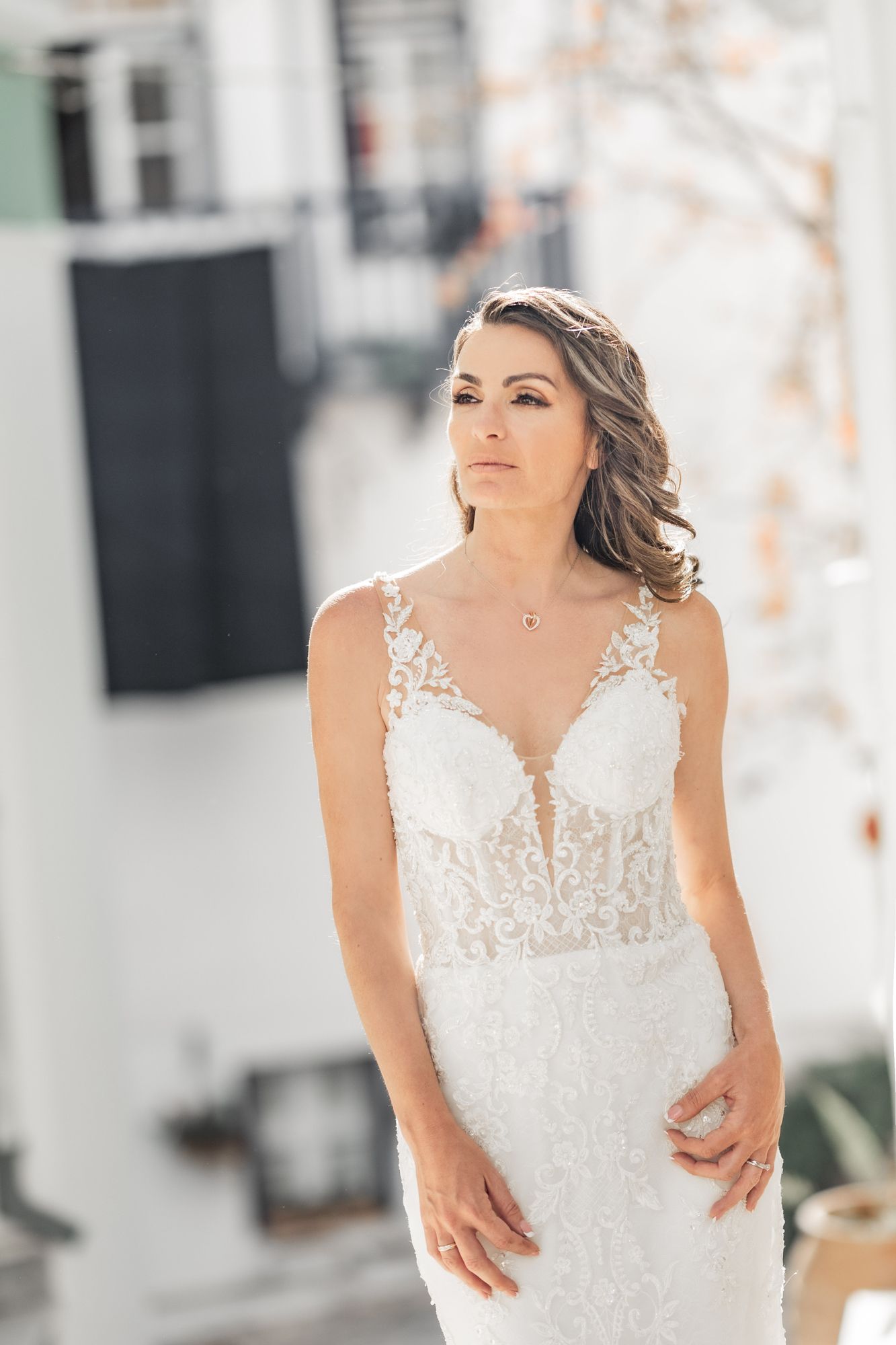 Close-up details of intricate lace wedding dress with delicate embellishments.