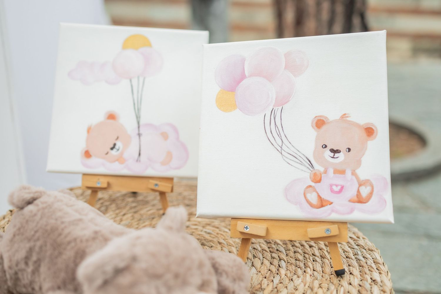 A collection of watercolor greeting cards featuring cute animal illustrations displayed with a teddy bear on a wooden surface.