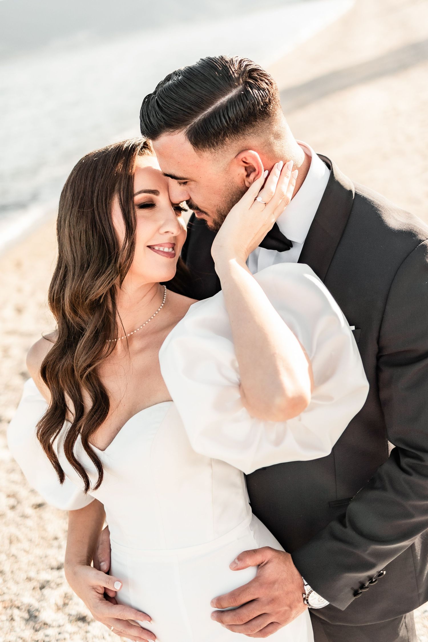 Intimate close-up wedding portraits captured on a sunny beach.