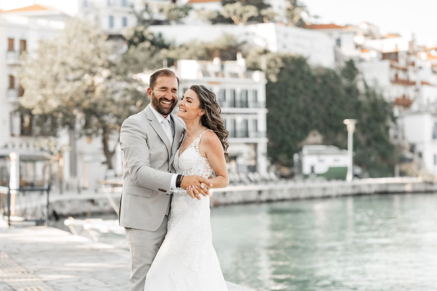Couple shares intimate dance moment along Mediterranean coastal promenade.