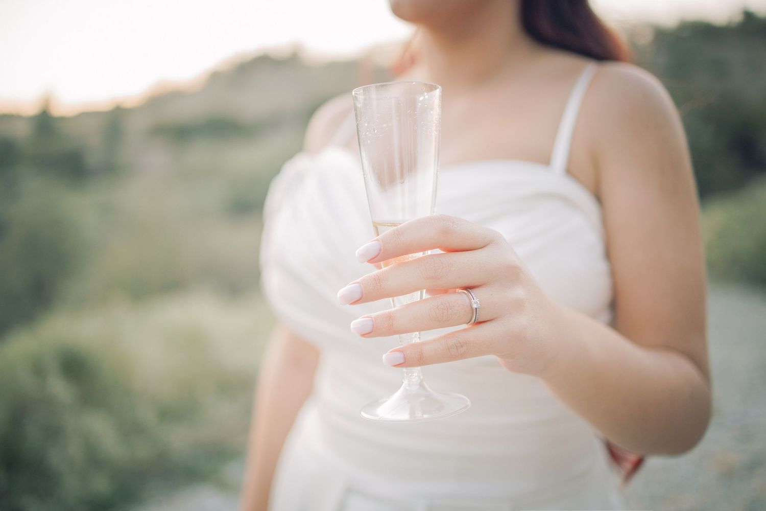 Elegant white wedding dress details shown in a series of close-up shots focusing on delicate fabric and lace elements.