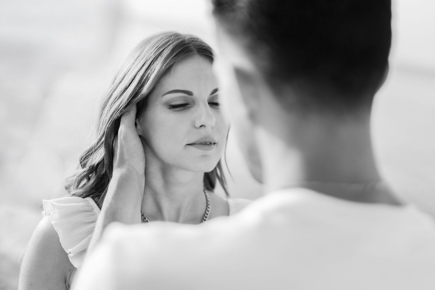 Black and white romantic wedding photo collage showing tender moments between a bride and groom.