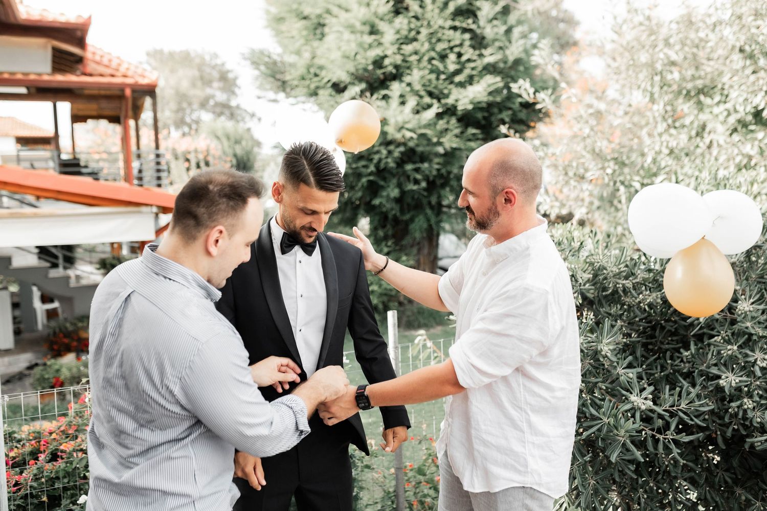 Celebratory moment between wedding party members in outdoor setting.